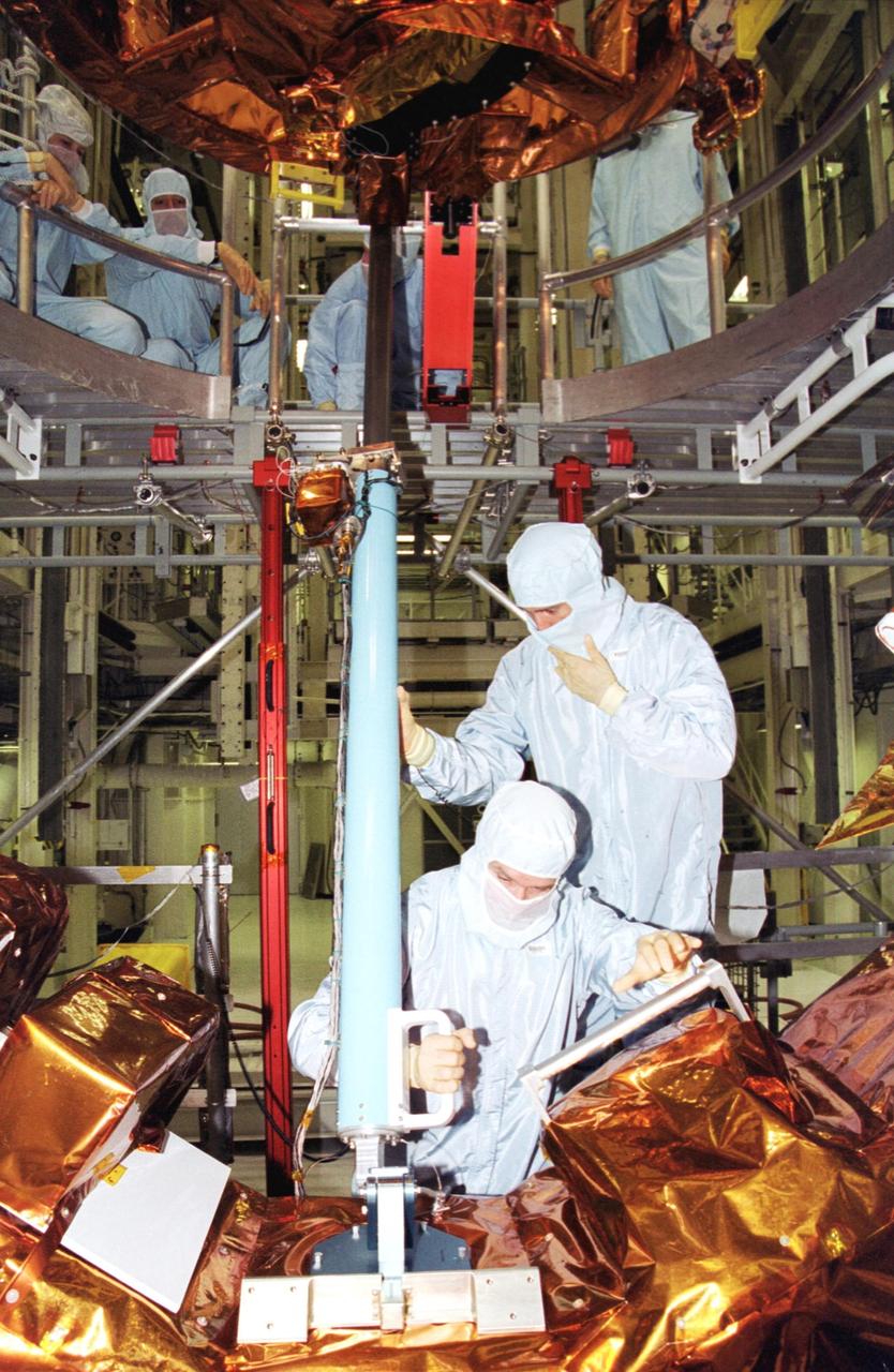 KENNEDY SPACE CENTER, Fla. - In the Vertical Processing Facility, members of the STS-109 crew practice on some of the equipment for their Hubble Space Telescope (HST) Servicing mission.  Seen in the foreground are (left) Payload Commander John Grunsfeld and (right) Mission Specialist James Newman.  The rest of the crew are Commander Scott Altman, Pilot Duane Carey, and Mission Specialists Nancy Currie, Richard Linnehan and Michael Massimino.  The goal of the mission is to service the HST, replacing Solar Array 2 with Solar Array 3, replacing the Power Control Unit, removing the Faint Object Camera and installing the Advanced Camera for Surveys, installing the Near Infrared Camera and Multi-Object Spectrometer (NICMOS) Cooling System, and installing New Outer Blanket Layer insulation on bays 5 through 8.  Mission STS-109 is scheduled for launch Feb. 14, 2002