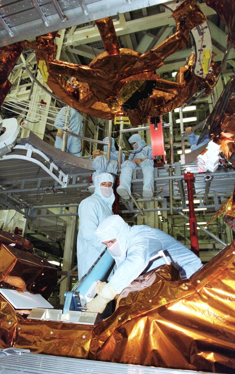 KENNEDY SPACE CENTER, Fla. - In the Vertical Processing Facility, members of the STS-109 crew practice using some of the equipment for their Hubble Space Telescope (HST) Servicing mission.  Seen in the foreground are Mission Specialists Michael Massimino (standing) and Richard Linnehan (bending over).  The rest of the crew members are Commander Scott Altman, Pilot Duane Carey, Payload Commander John Grunsfeld and Mission Specialists Nancy Currie and James Newman.  The goal of the mission is to service the HST, replacing Solar Array 2 with Solar Array 3, replacing the Power Control Unit, removing the Faint Object Camera and installing the Advanced Camera for Surveys, installing the Near Infrared Camera and Multi-Object Spectrometer (NICMOS) Cooling System, and installing New Outer Blanket Layer insulation on bays 5 through 8.  Mission STS-109 is scheduled for launch Feb. 14, 2002