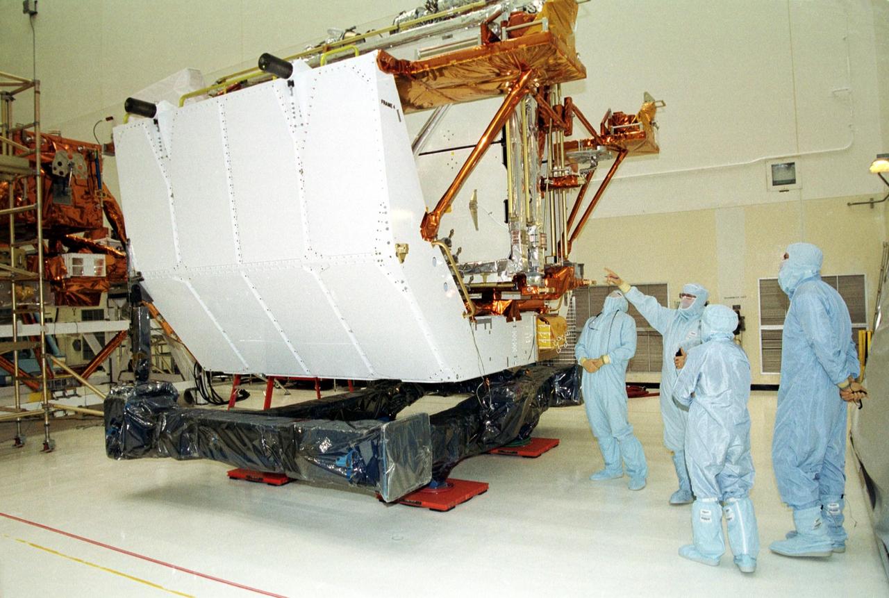 KENNEDY SPACE CENTER, Fla. -- In the Vertical Processing Facility, members of the STS-109 crew look over the Solar Array 3 panels that will be replacing Solar Array 2 panels on the Hubble Space Telescope (HST).  Trainers, at left, point to the panels while Mission Specialist Nancy Currie (second from right) and Commander Scott Altman (far right) look on. Other crew members are Pilot Duane Carey, Payload Commander John Grunsfeld and Mission Specialists James Newman, Richard Linnehan and Michael Massimino.  The other goals of the mission are replacing the Power Control Unit, removing the Faint Object Camera and installing the Advanced Camera for Surveys, installing the Near Infrared Camera and Multi-Object Spectrometer (NICMOS) Cooling System, and installing New Outer Blanket Layer insulation on bays 5 through 8. Mission STS-109 is scheduled for launch Feb. 14, 2002