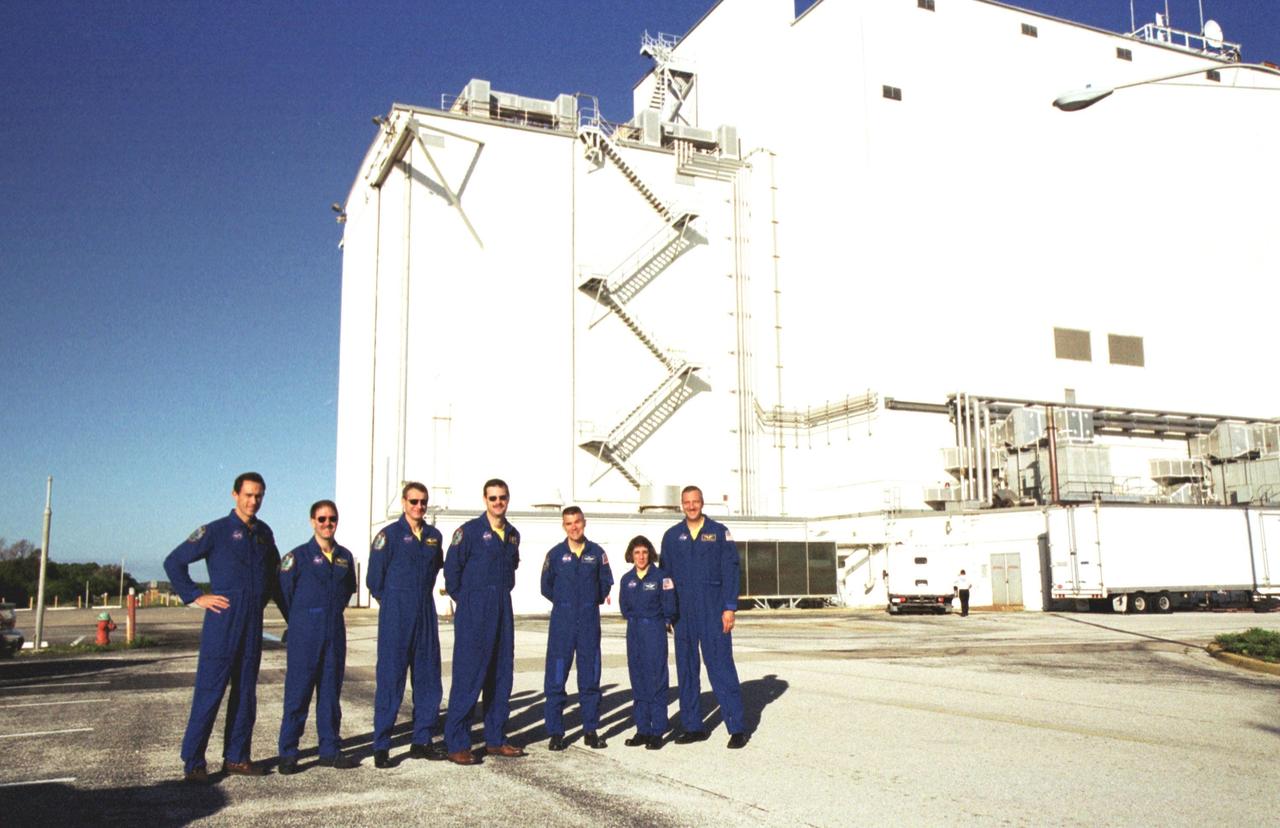 KENNEDY SPACE CENTER, Fla. --   The STS-109 crew poses for a group photo outside the Vertical Processing Facility at KSC.   From left are Mission Specialist James Newman, Payload Commander John Grunsfeld, Mission Specialist Richard Linnehan, Commander Scott Altman, Pilot Duane Carey, and Mission Specialists Nancie Currie and Michael Massimino.  STS-109 is the Hubble Space Telescope (HST) Servicing mission.  The crew comprises Commander Scott Altman, Pilot Duane Carey, Payload Commander John Grunsfeld and Mission Specialists Nancy Currie, James Newman, Richard Linnehan and Michael Massimino.  The goal of the mission is to service the HST, replacing Solar Array 2 with Solar Array 3, replacing the Power Control Unit, removing the Faint Object Camera and installing the Advanced Camera for Surveys, installing the Near Infrared Camera and Multi-Object Spectrometer (NICMOS) Cooling System, and installing New Outer Blanket Layer insulation on bays 5 through 8.  Mission STS-109 is scheduled for launch Feb. 14, 2002