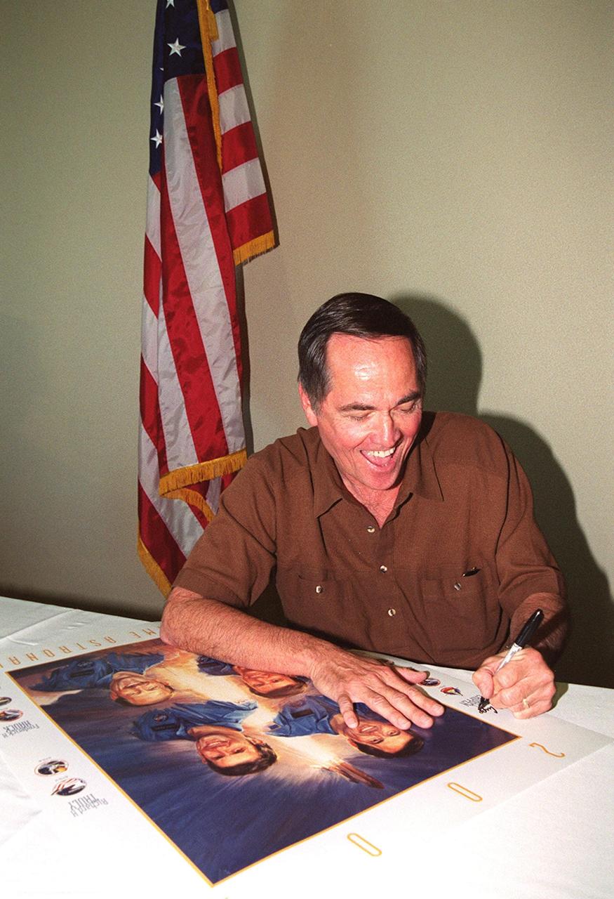 KENNEDY SPACE CENTER, Fla. --  One of the first Shuttle astronauts, Robert Crippen signs a poster during induction ceremonies into the U.S. Astronaut Hall of Fame Nov. 10.  He shared the induction honor with astronauts Richard Truly, Joe Engle, and Frederick "Rick" Hauck. The event took place at the KSC Visitor Complex