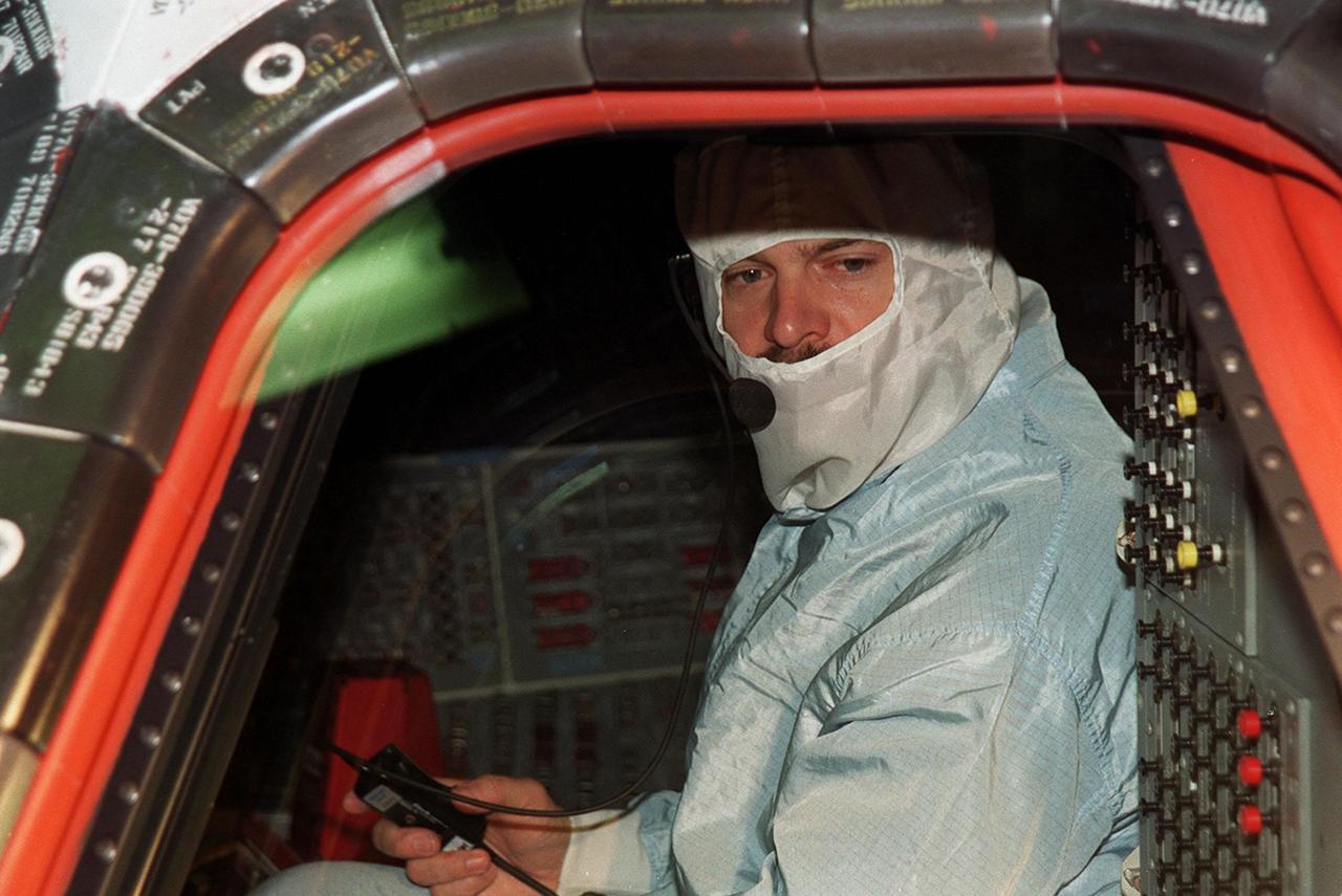 KENNEDY SPACE CENTER, Fla. --  STS-109 Commander Scott Altman checks the windshield and windows from inside Columbia.  He and the crew are at KSC to take part in Crew Equipment Interface Test activities that include familiarization with the orbiter and equipment. STS-109 is the Hubble Space Telescope (HST) Servicing mission.  The crew also comprises Pilot Duane Carey, Payload Commander John Grunsfeld and Mission Specialists Nancy Currie, James Newman, Richard Linnehan and Michael Massimino.  The goal of the mission is to service the HST, replacing Solar Array 2 with Solar Array 3, replacing the Power Control Unit, removing the Faint Object Camera and installing the Advanced Camera for Surveys, installing the Near Infrared Camera and Multi-Object Spectrometer (NICMOS) Cooling System, and installing New Outer Blanket Layer insulation on bays 5 through 8.  Mission STS-109 is scheduled for launch Feb. 14, 2002