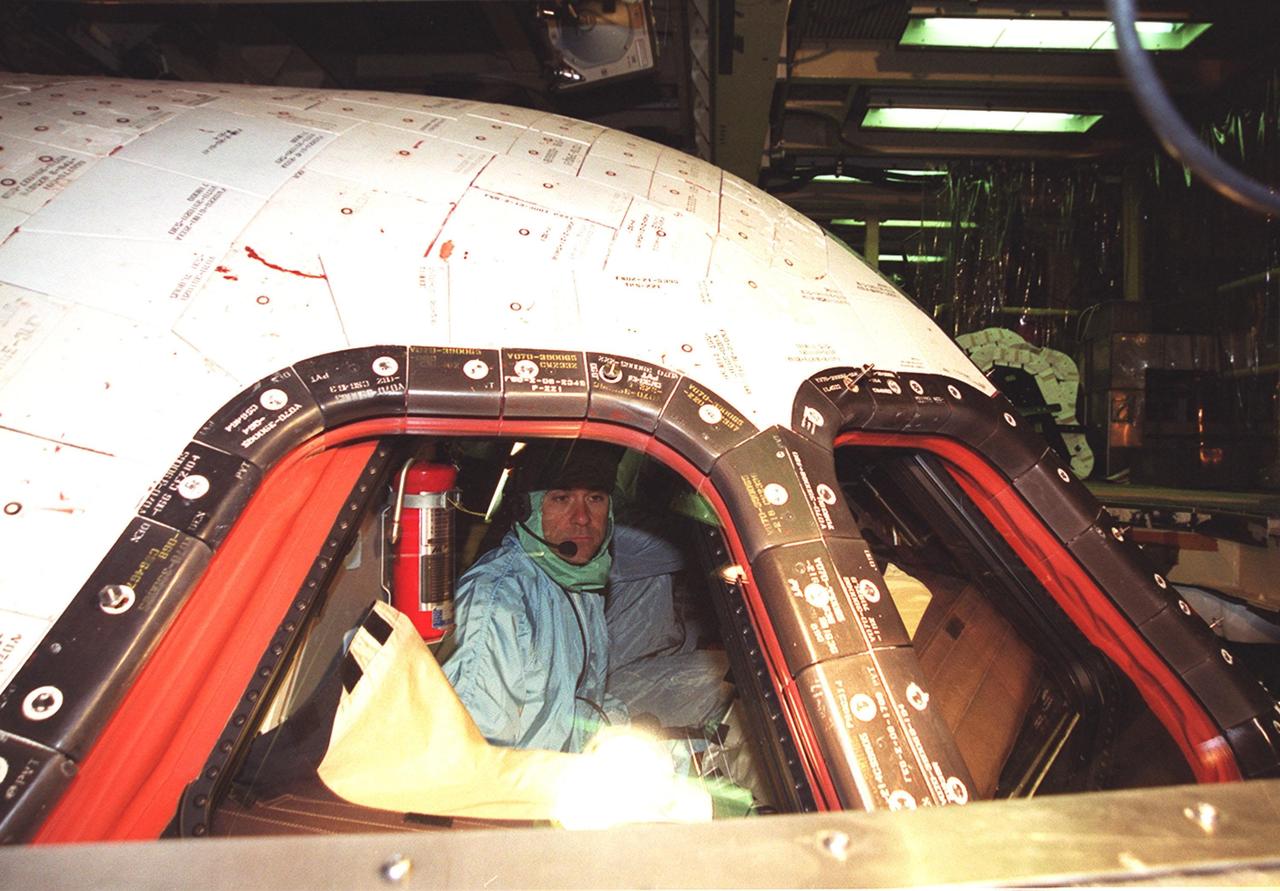 KENNEDY SPACE CENTER, Fla. - STS-109 Pilot Duane Carey checks the windshield and windows from inside Columbia. This is Carey's first Shuttle flight. He and the crew are at KSC to take part in Crew Equipment Interface Test activities that include familiarization with the orbiter and equipment. STS-109 is the Hubble Space Telescope (HST) Servicing mission. The crew also comprises Commander Scott Altman, Payload Commander John Grunsfeld and Mission Specialists Nancy Currie, James Newman, Richard Linnehan and Michael Massimino. The goal of the mission is to service the HST, replacing Solar Array 2 with Solar Array 3, replacing the Power Control Unit, removing the Faint Object Camera and installing the Advanced Camera for Surveys, installing the Near Infrared Camera and Multi-Object Spectrometer (NICMOS) Cooling System, and installing New Outer Blanket Layer insulation on bays 5 through 8. Mission STS-109 is scheduled for launch Feb. 14, 2002