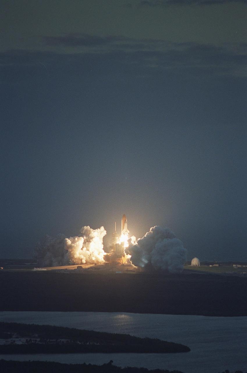 KENNEDY SPACE CENTER, FLA. --  Viewed from the roof of the Vehicle Assembly Building, Space Shuttle Endeavour rises from between billows of smoke and steam to begin its journey to the International Space Station on mission STS-108. Liftoff occurred at 5:19:28 p.m. EST (22:19:28 GMT).  Endeavour will dock with the International Space Station on Dec. 7.  STS-108 is the final Shuttle mission of 2001and the 107th Shuttle flight overall.  It is the 12th flight to the Space Station.  Landing of the orbiter at KSC's Shuttle Landing Facility is targeted for 1:05 p.m. EST (18:05 p.m. GMT) Dec. 16
