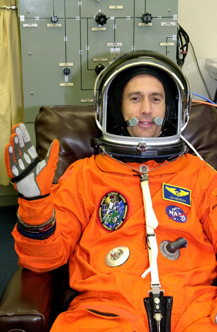 KENNEDY SPACE CENTER, FLA. -- STS-109 Mission Specialist James Newman waves during suit check, which is part of Terminal Countdown Demonstration Test activities.   He and other crew members - Commander Scott Altman, Pilot Duane Carey, Payload Commander John Grunsfeld and Mission Specialists Nancy Currie, Richard Linnehan and Michael Massimino - are at Kennedy for the TCDT that also includes emergency egress training and a simulated countdown.  Columbia is scheduled to be launched Feb. 28 on mission STS-109, a Hubble Servicing Mission. The goal of the mission is to replace Solar Array 2 with Solar Array 3, replace the Power Control Unit, remove the Faint Object Camera and install the ACS, install the Near Infrared Camera and Multi-Object Spectrometer (NICMOS) Cooling System, and install New Outer Blanket Layer insulation.  The launch will be the first for Columbia after returning from California where it underwent extensive maintenance, inspections and enhancements. More than 100 upgrades make Columbia safer and more reliable than ever before