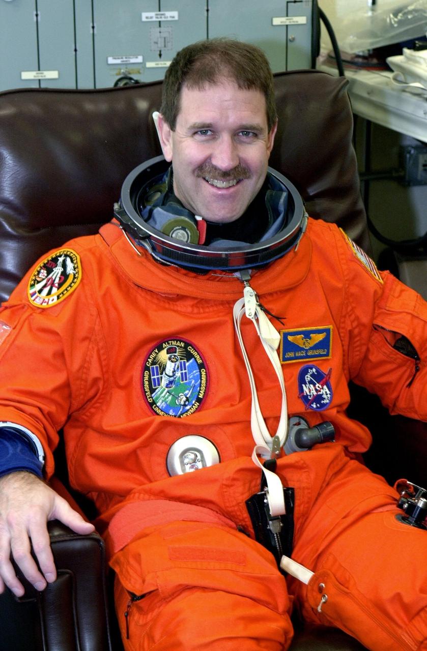KENNEDY SPACE CENTER, FLA. --  STS-109 Payload Commander John Grunsfeld relaxes during suit check, which is part of Terminal Countdown Demonstration Test activities.   He and other crew members - Commander Scott Altman, Pilot Duane Carey and Mission Specialists Nancy Currie, James Newman, Richard Linnehan and Michael Massimino - are at Kennedy for the TCDT that also includes emergency egress training and a simulated countdown.  Columbia is scheduled to be launched Feb. 28 on mission STS-109, a Hubble Servicing Mission. The goal of the mission is to replace Solar Array 2 with Solar Array 3, replace the Power Control Unit, remove the Faint Object Camera and install the ACS, install the Near Infrared Camera and Multi-Object Spectrometer (NICMOS) Cooling System, and install New Outer Blanket Layer insulation.  The launch will be the first for Columbia after returning from California where it underwent extensive maintenance, inspections and enhancements. More than 100 upgrades make Columbia safer and more reliable than ever before