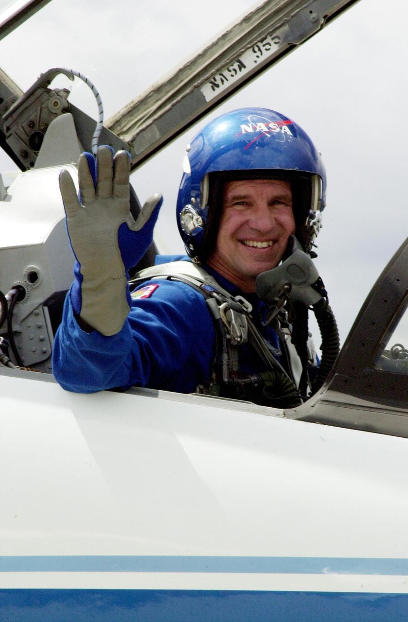 KENNEDY SPACE CENTER, FLA. --   STS-110 Commander Michael Bloomfield waves as he gets ready to depart KSC for Houston.  He and the rest of the crew were at KSC for Terminal Countdown Demonstration Test activities that included payload familiarization and a simulated launch countdown. Scheduled for launch April 4, the 11-day STS-110 mission will feature Space Shuttle Atlantis docking with the International Space Station (ISS) and delivering the S0 truss, the centerpiece-segment of the primary truss structure that will eventually extend over 300 feet