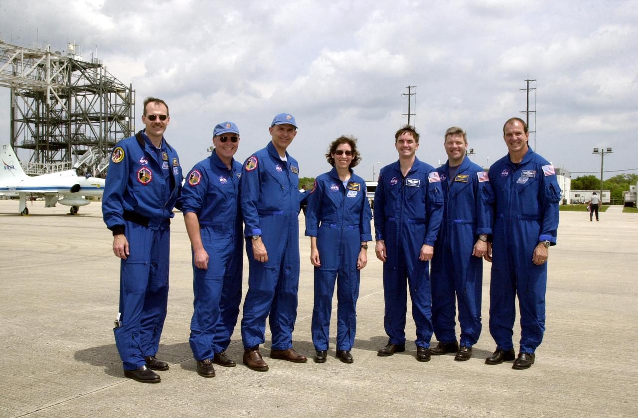 KENNEDY SPACE CENTER, FLA. --  The STS-110 crew poses for a photo after landing at the KSC Shuttle Landing Facility. Standing left to right are Mission Specialists Steven Smith, Jerry Ross, Lee Morin, Ellen Ocho and Rex Walheim; Pilot Stephen Frick; and Commander Michael Bloomfield. Mission STS-110 is the 13th assembly flight to the International Space Station.  During four planned spacewalks, crew members will install the S0 Integrated Truss Structure (ITS), centerpiece of the orbiting International Space Station (ISS), at the center of the 10-truss, girderlike structure that will ultimately extend the length of a football field on the ISS.   The S0 truss will be attached to the U.S. Lab, "Destiny,"  on the 11-day mission