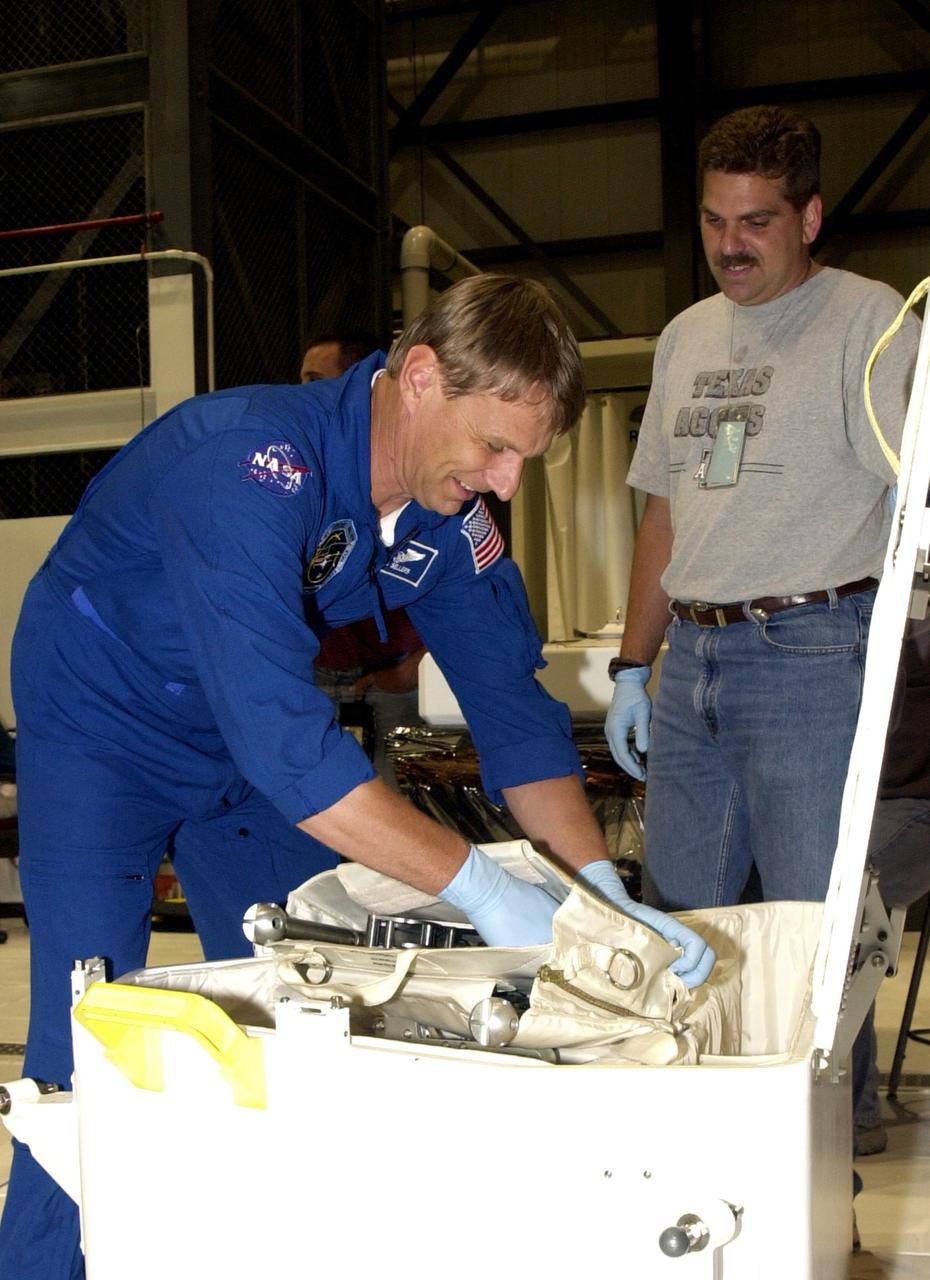 KENNEDY SPACE CENTER, FLA. - STS-112 Mission Specialist Piers Sellers checks out flight equipment during a Crew Equipment Interface Test at KSC. STS-112 is the 15th assembly flight to the International Space Station and will be ferrying the S1 Integrated Truss Structure. The S1 truss is the first starboard (right-side) truss segment, whose main job is providing structural support for the radiator panels that cool the Space Station's complex power system. The S1 truss segment also will house communications systems, external experiment positions and other subsystems. The S1 truss will be attached to the S0 truss. STS-112 is currently scheduled for launch Aug. 22, 2002