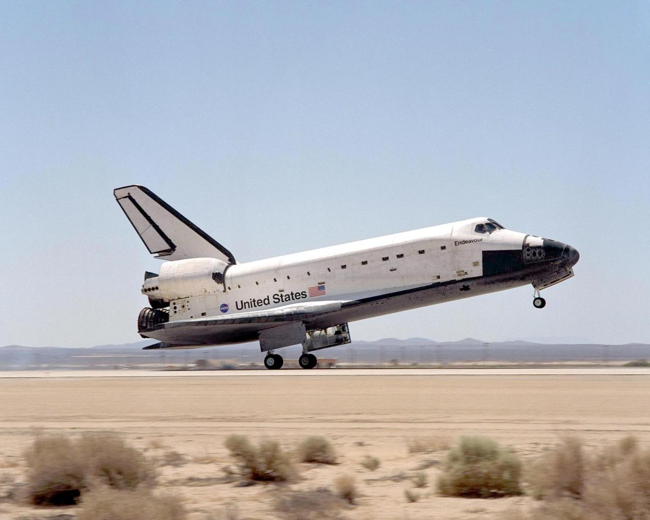 EDWARDS AFB, CALIF. -- After traveling 5.8 million miles in space during 217 orbits, Endeavour touches down on concrete runway 22 at Dryden Flight Research Center, Edwards Air Force Base, Calif., completing mission STS-111. Three days of unfavorable weather conditions at KSC prompted the decision to land at Edwards, which enjoyed pristine, dry conditions.. Main gear touchdown occurred at 1:57:41 p.m. EDT, nose gear touchdown at 1:57:53 p.m. EDT and wheel stop at 1:58:45 p.m. EDT. 
