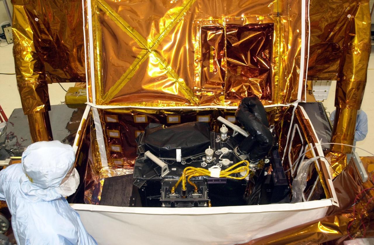 KENNEDY SPACE CENTER, FLA. -- The Near Infrared Camera and Multi-Object Spectrometer (NICMOS) Cooling System rests inside a protective enclosure on a payload carrier. NICMOS II is part of the payload on mission STS-109, the Hubble Servicing Telescope Mission. It is a new experimental cooling system consisting of a compressor and tiny turbines. With the experimental cryogenic system, NASA hopes to re-cool the infrared detectors to below -315 degrees F (-193 degrees Celsius). NICMOS II was previously tested aboard STS-95 in 1998. It could extend the life of the Hubble Space Telescope by several years. Astronauts aboard Columbia on mission STS-109 will be replacing the original NICMOS with the newer version. Launch of mission STS-109 is scheduled for Feb. 28, 2002