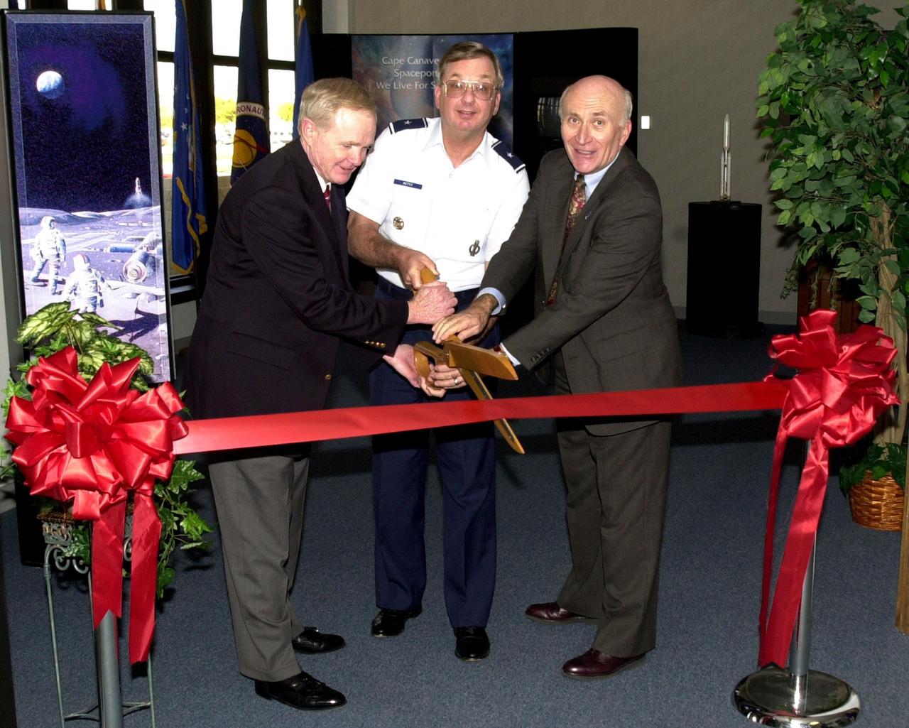 KENNEDY SPACE CENTER, FLA. --   (From left) Center Director Roy Bridges, Brig. Gen. Donald P. Pettit  and Executive Director of the Cape Canaveral Spaceport Management Office Ed Gormel share the ribbon cutting at the formal opening of a Customer Service office at the Spaceport.  Gen. Pettit is the commander of the 45th Space Wing