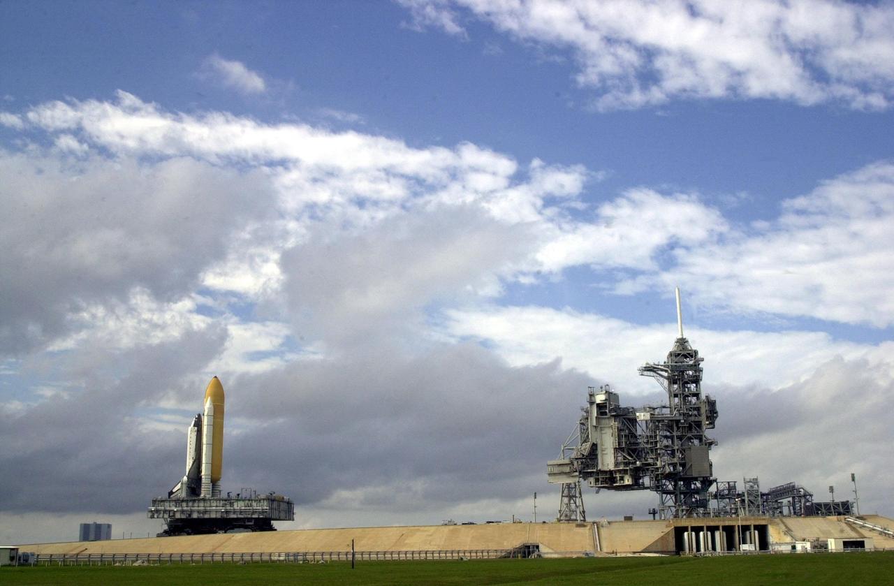KENNEDY SPACE CENTER, FLA. -- Space Shuttle Columbia, atop its Mobile Launcher Platform, inches its way along the path to Launch Pad 39A. Columbia is scheduled to be launched Feb. 28 on mission STS-109, a Hubble Servicing Mission. The goal of the mission is to replace Solar Array 2 with Solar Array 3, replace the Power Control Unit, remove the Faint Object Camera and install the ACS, install the Near Infrared Camera and Multi-Object Spectrometer (NICMOS) Cooling System, and install New Outer Blanket Layer insulation. The launch will be the first for Columbia after returning from California where it underwent extensive maintenance, inspections and enhancements. More than 100 upgrades make Columbia safer and more reliable than ever before