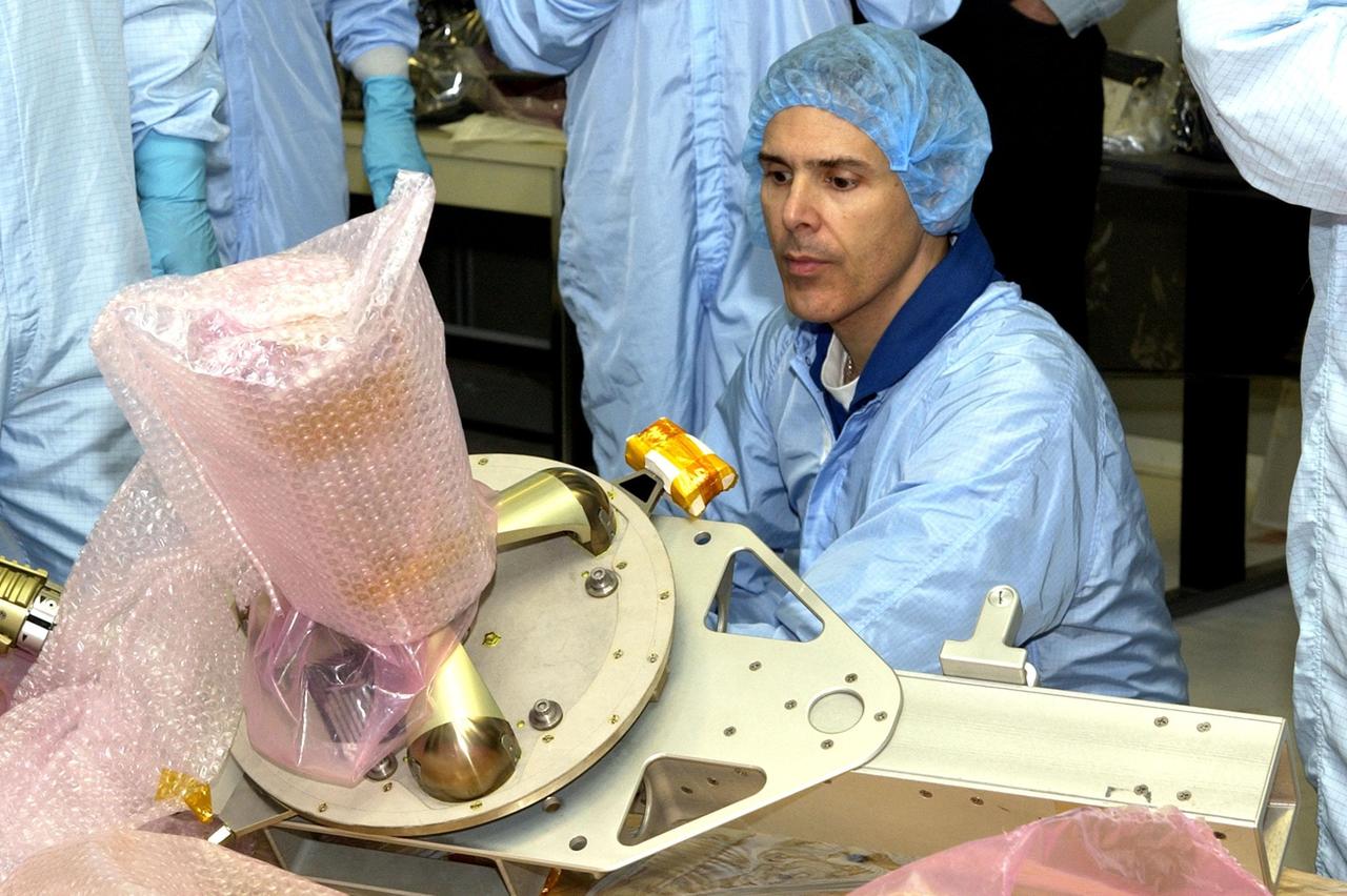 KENNEDY SPACE CENTER, FLA. -- In the Operations and Checkout Building, STS-110 Mission Specialist Lee Morin looks over equipment that will be on the mission. Other crew members (not shown) are Commander Michael J. Bloomfield, Pilot Stephen N. Frick, and Mission Specialists Steven L. Smith, Ellen Ochoa and Rex J. Walheim. Part of the payload on the mission is the Integrated Truss Structure S0.  It is the center segment that they will be installing on the International Space Station, part of the 300-foot (91-meter) truss attached to the U.S. Lab. By assembly completion, four more truss segments will attach to either side of the S0 truss.  STS-110 is currently scheduled to launch in April 2002