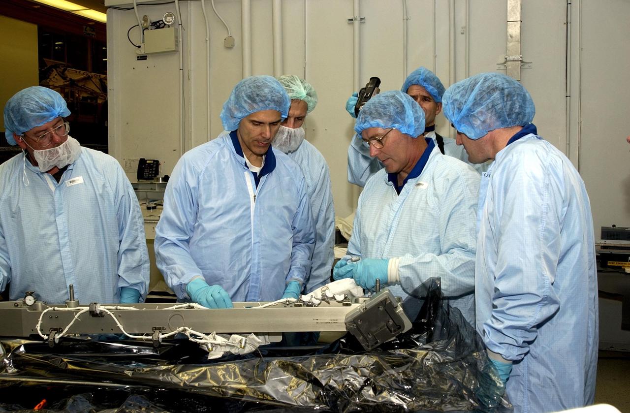 KENNEDY SPACE CENTER, FLA. -- In the Operations and Checkout Building, members of the STS-110 crew check out equipment that will be on their mission.  From left are Mission Specialists Steven Smith, Lee Morin, Jerry Ross and Rex Walheim.  Other crew members (not shown) are Commander Michael J. Bloomfield, Pilot Stephen N. Frick, and Mission Specialist Ellen Ochoa. Part of the payload on the mission is the Integrated Truss Structure S0.  It is the center segment that they will be installing on the International Space Station, part of the 300-foot (91-meter) truss attached to the U.S. Lab. By assembly completion, four more truss segments will attach to either side of the S0 truss.  STS-110 is currently scheduled to launch in April 2002