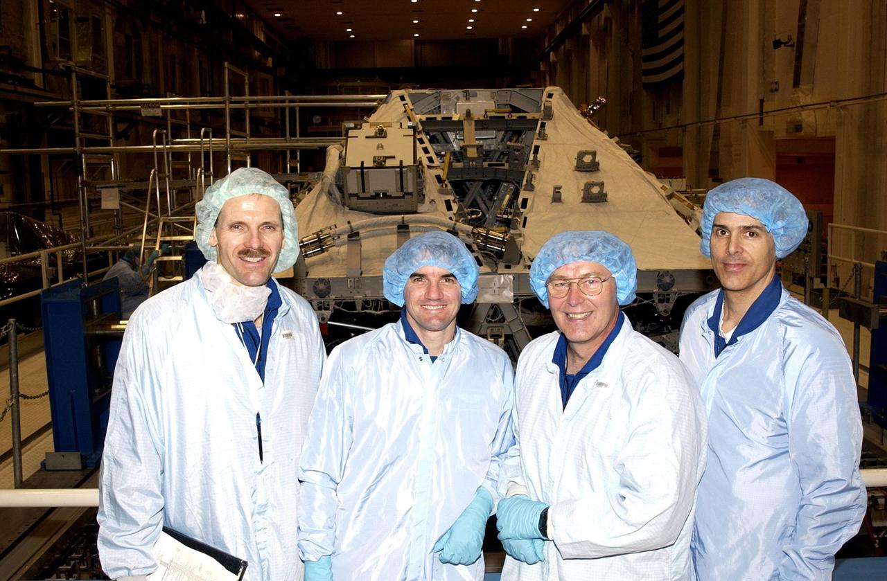 KENNEDY SPACE CENTER, FLA. --  In the Operations and Checkout Building, members of the STS-110 crew take a break from checking equipment to pose for a photo: (from left) Mission Specialists Steven Smith, Rex Walheim, Jerry Ross and Lee Morin. Other crew members (not shown) are Commander Michael J. Bloomfield, Pilot Stephen N. Frick, and Mission Specialist Ellen Ochoa. Part of the payload on the mission is the Integrated Truss Structure S0.  It is the center segment that they will be installing on the International Space Station, part of the 300-foot (91-meter) truss attached to the U.S. Lab. By assembly completion, four more truss segments will attach to either side of the S0 truss.  STS-110 is currently scheduled to launch in April 2002