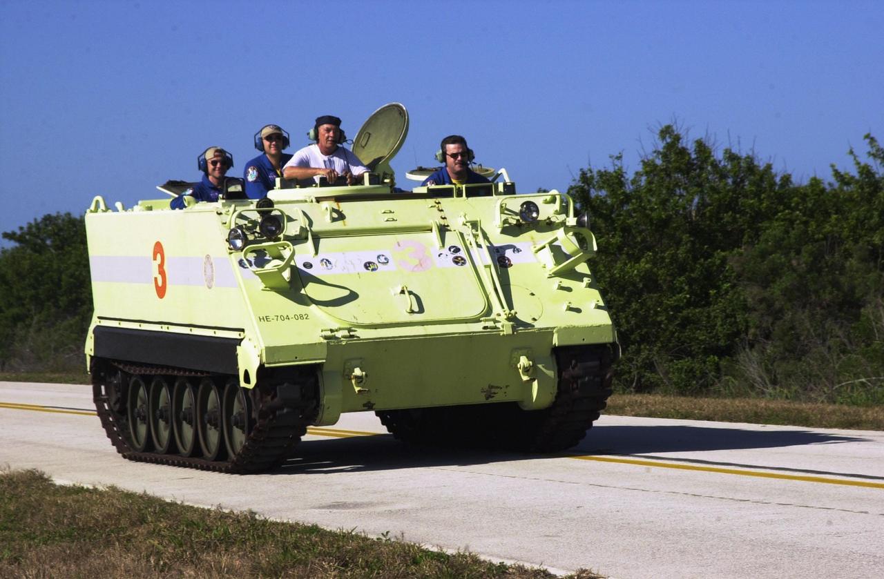 KENNEDY SPACE CENTER, FLA. - STS-109 Commander Scott Altman drives the M-113 armored personnel carrier during emergency egress training at the launch pad. He and other crew members are taking part in Terminal Countdown Demonstration Test activities, which also include a simulated launch countdown. STS-109 is a Hubble Space Telescope Servicing Mission, with goals to replace Solar Array 2 with Solar Array 3, replace the Power Control Unit, remove the Faint Object Camera and install the Advanced Camera for Surveys (ACS), install the Near Infrared Camera and Multi-Object Spectrometer (NICMOS) Cooling System, and install New Outer Blanket Layer insulation. The 11-day mission will require grasping the satellite with a robotic arm in order for the crew to perform the tasks during five spacewalks. Launch of STS-109 aboard Space Shuttle Columbia is scheduled for Feb. 28, 2002