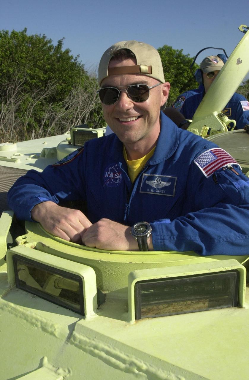KENNEDY SPACE CENTER, FLA. - STS-109 Pilot Duane Carey is ready to practice driving the M-113 armored personnel carrier, part of emergency egress training at the launch pad. He and other crew members are taking part in Terminal Countdown Demonstration Test activities, which also include a simulated launch countdown. STS-109 is a Hubble Space Telescope Servicing Mission, with goals to replace Solar Array 2 with Solar Array 3, replace the Power Control Unit, remove the Faint Object Camera and install the Advanced Camera for Surveys (ACS), install the Near Infrared Camera and Multi-Object Spectrometer (NICMOS) Cooling System, and install New Outer Blanket Layer insulation. The 11-day mission will require grasping the satellite with a robotic arm in order for the crew to perform the tasks during five spacewalks. Launch of STS-109 aboard Space Shuttle Columbia is scheduled for Feb. 28, 2002