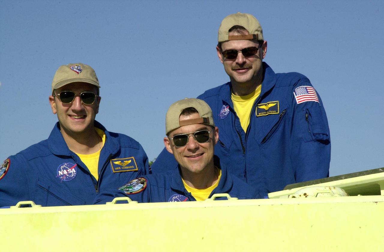 KENNEDY SPACE CENTER, FLA. - During training on an M-113 armored personnel carrier, members of the STS-109 crew pause for this photo. From left are pictured Mission Specialist Michael Massimino, Pilot Duane Carey and Commander Scott Altman. The M-113 is part of emergency egress training at the launch pad. Crew members are taking part in Terminal Countdown Demonstration Test activities, which also include a simulated launch countdown. STS-109 is a Hubble Space Telescope Servicing Mission, with goals to replace Solar Array 2 with Solar Array 3, replace the Power Control Unit, remove the Faint Object Camera and install the Advanced Camera for Surveys (ACS), install the Near Infrared Camera and Multi-Object Spectrometer (NICMOS) Cooling System, and install New Outer Blanket Layer insulation. The 11-day mission will require grasping the satellite with a robotic arm in order for the crew to perform the tasks during five spacewalks. Launch of STS-109 aboard Space Shuttle Columbia is scheduled for Feb. 28, 2002