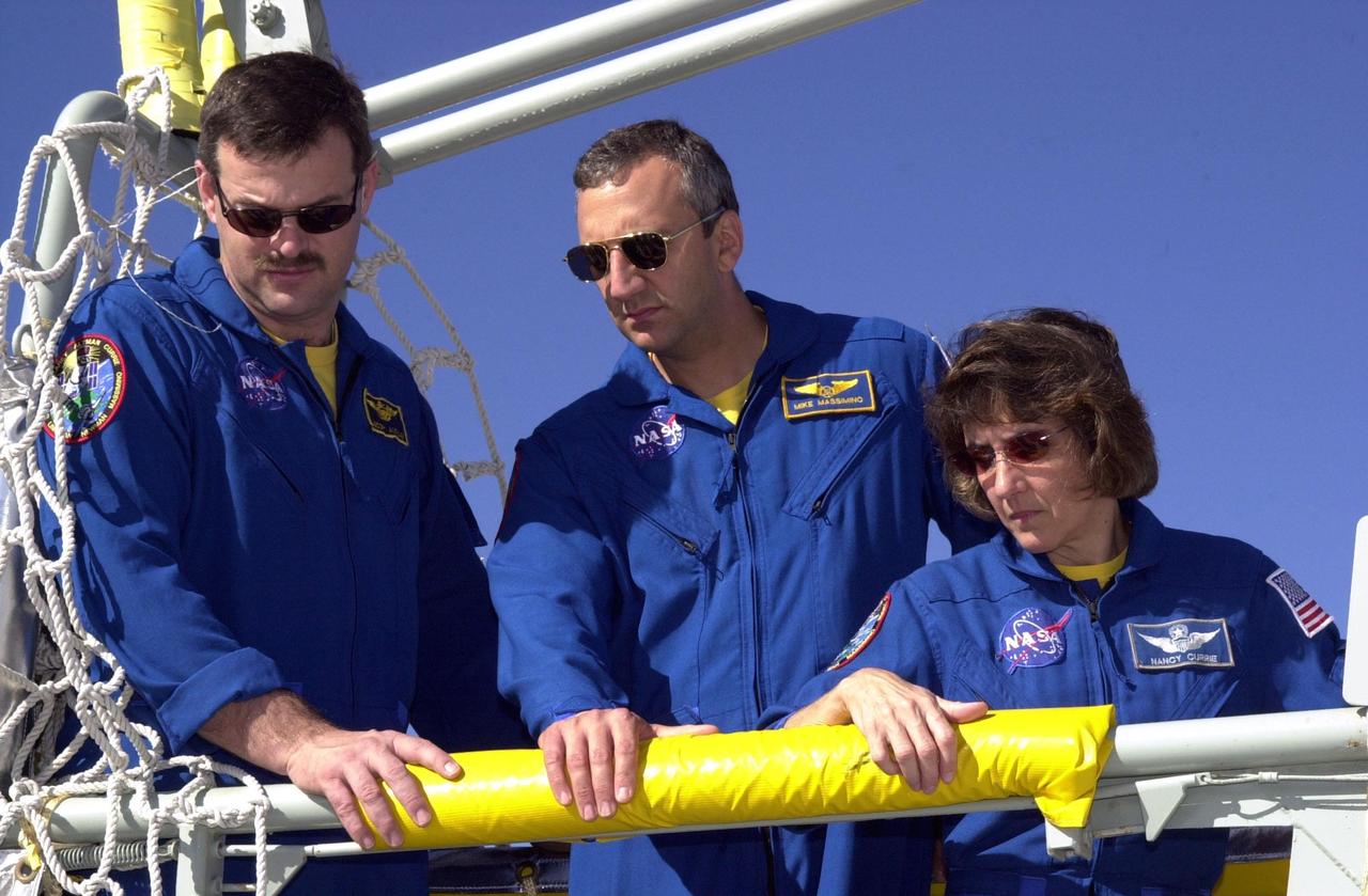 KENNEDY SPACE CENTER, FLA. - Near the bunker at the bottom of Launch Pad 39A, the STS-109 crew takes part in slidewire basket/emergency egress training.  In the slidewire basket are (left to right) Commander Scott Altman and Mission Specialists Michael Massimino and Nancy Currie. The training is part of Terminal Countdown Demonstration Test activities that include a simulated countdown at the pad.  Columbia is scheduled to be launched Feb. 28 on mission STS-109, a Hubble Servicing Mission. The goal of the mission is to replace Solar Array 2 with Solar Array 3, replace the Power Control Unit, remove the Faint Object Camera and install the ACS, install the Near Infrared Camera and Multi-Object Spectrometer (NICMOS) Cooling System, and install New Outer Blanket Layer insulation. .  The launch will be the first for Columbia after returning from California where it underwent extensive maintenance, inspections and enhancements. More than 100 upgrades make Columbia safer and more reliable than ever before