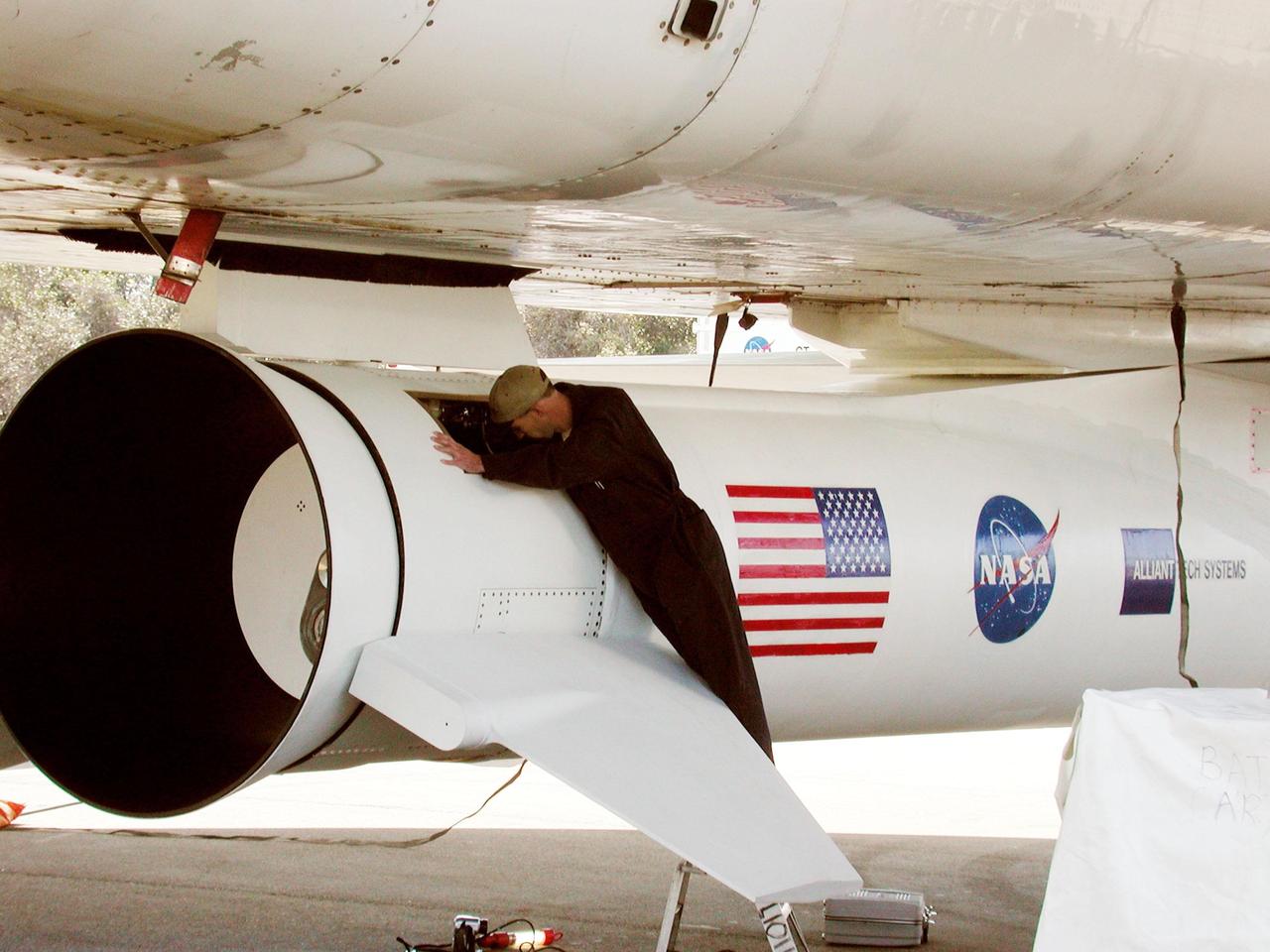 KENNEDY SPACE CENTER, FLA. -- At Cape Canaveral Air Force Station, Fla., Mark McManus makes a final inspection of the first stage aft skirt on the Pegasus XL rocket, the vehicle that will launch the High Energy Solar Spectroscopic Imager (HESSI). The primary mission of HESSI is to explore the basic physics of particle acceleration and energy release in solar flares. The launch of PegasusXL/HESSI is scheduled for Feb. 5, 2002, from beneath the Orbital Sciences Corp. L-1011 aircraft seen here