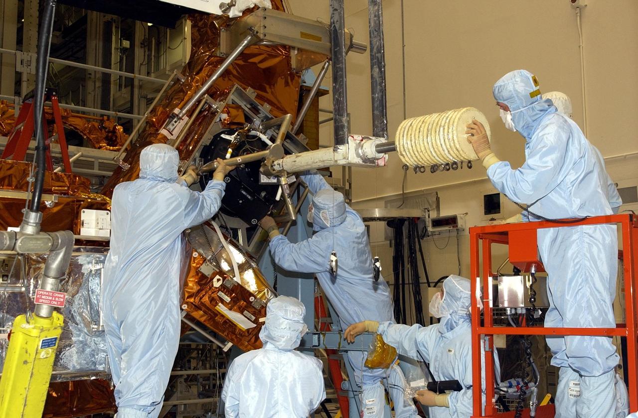 KENNEDY SPACE CENTER, FLA. - Workers in the Vertical Processing Facility check the position of the Hubble Space Telescope's replacement Reaction Wheel Actuator on the Large Orbital Protective Enclosure (LOPE), which is contained in the Multi-Use Lightweight Equipment (MULE) for flight. Part of Hubble's Pointing Control System, the actuators receiving information from sensors and physically adjust Hubble's position and orientation so that Hubble can view the required celestial bodies. The reaction wheels work by rotating a large flywheel up to 3000 rpm or braking it to exchange momentum with the spacecraft which will make Hubble turn. The RWA is part of the payload on mission STS-109, the Hubble Servicing Mission, scheduled to launch Feb. 28, 2002