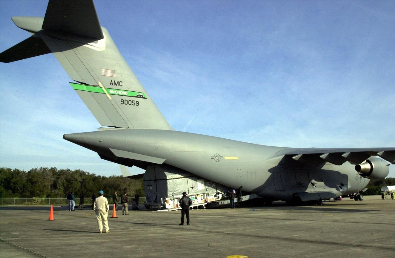 KENNEDY SPACE CENTER, FLA. --  At KSC's Shuttle Landing Facility, the Air Force C-17 air cargo plane offloads the Tracking and Data Relay Satellite-I (TDRS-I).  The second in a new series of telemetry satellites, TDRS-I replenishes the existing on-orbit fleet of six spacecraft.  The TDRS System is the primary source of space-to-ground voice, data and telemetry for the Space Shuttle.  It also provides communications with the International Space Station and scientific spacecraft in low-Earth orbit such as the Hubble Space Telescope.  This new advanced series of satellites will extend the availability of TDRS communications services until about 2017. TDRS-I will undergo processing in the Spacecraft Assembly and Encapsulation Facility-2 (SAEF-2) to prepare it for launch March 8 aboard a Lockheed Martin Atlas IIA rocket from Pad 36-A, Cape Canaveral Air Force Station