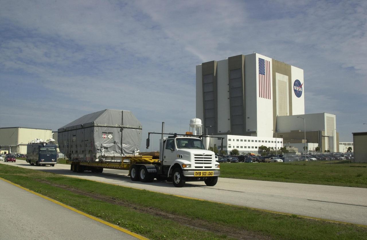 KENNEDY SPACE CENTER, FLA. --  -- At KSC's Shuttle Landing Facility, the Tracking and Data Relay Satellite-I (TDRS-I) is transported from the Shuttle Landing Facility to the Spacecraft Assembly and Encapsulation Facility-2 (SAEF-2). The second in a new series of telemetry satellites, TDRS-I replenishes the existing on-orbit fleet of six spacecraft.  The TDRS System is the primary source of space-to-ground voice, data and telemetry for the Space Shuttle.  It also provides communications with the International Space Station and scientific spacecraft in low-Earth orbit such as the Hubble Space Telescope.  This new advanced series of satellites will extend the availability of TDRS communications services until about 2017. In the SAEF-2 TDRS-I will undergo processing to prepare it for launch March 8 aboard a Lockheed Martin Atlas IIA rocket from Pad 36-A, Cape Canaveral Air Force Station