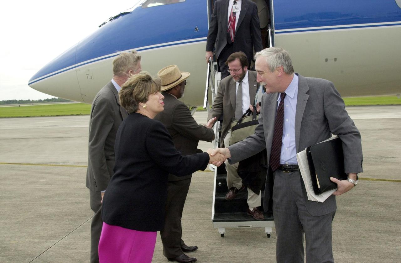 KENNEDY SPACE CENTER, Fla. --    The new NASA Administrator Sean O'Keefe (right) is greeted by KSC's Director of External Relations and Business Development JoAnn H. Morgan (left) after his arrival at KSC.  Next to Morgan is Deputy Director James Jennings, also greeting others exiting the plane.  O'Keefe is touring agency field centers.   O'Keefe was nominated for the position as administrator in November 2001 by President George W. Bush.  He was sworn in Dec. 21 as the agency's 10th chief