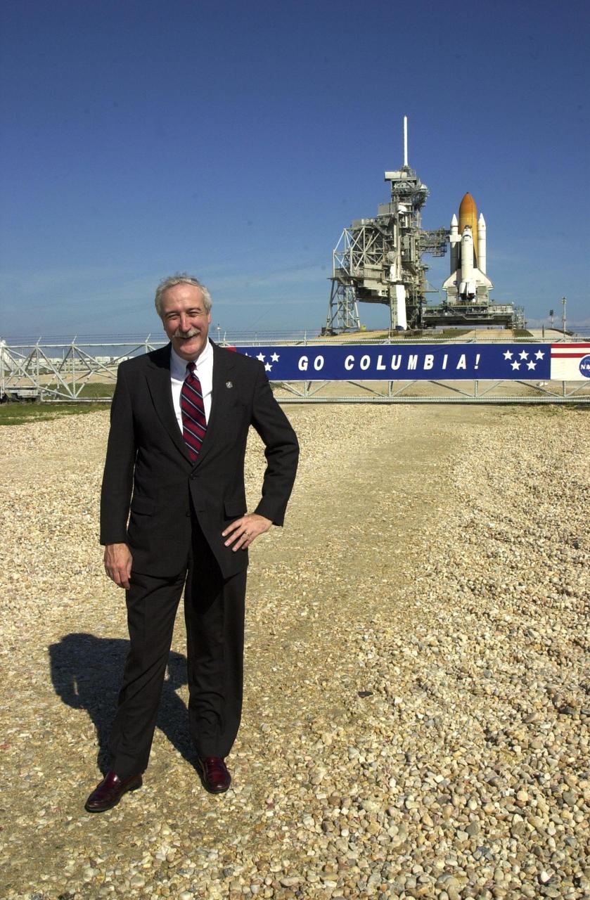KENNEDY SPACE CENTER, Fla. -  The new NASA Administrator Sean O'Keefe poses for the photographer near Launch Pad 39A.  Space Shuttle Columbia is poised on the pad behind him for launch Feb. 28 and mission STS-109.  The administrator was at KSC on an agencywide familiarization tour of NASA field centers.  He was nominated for the position as administrator in November 2001 by President George W. Bush.  He was sworn in Dec. 21 as the agency's 10th chief