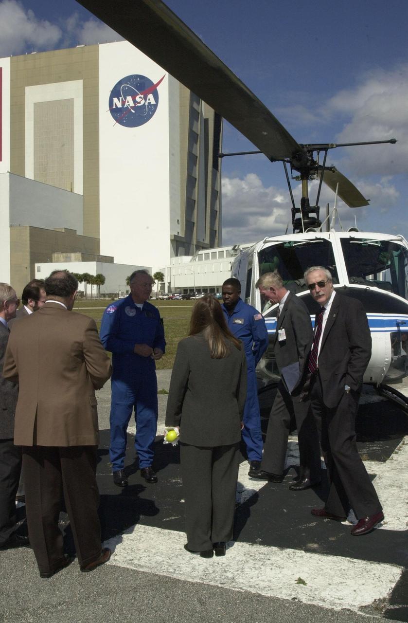 KENNEDY SPACE CENTER, Fla. -  The new NASA Administrator Sean O'Keefe prepares to board a helicopter, near the Vehicle Assembly Building (background), for an aerial tour of KSC.    The administrator was at KSC on an agencywide familiarization tour of NASA field centers.  He was nominated for the position as administrator in November 2001 by President George W. Bush.  He was sworn in Dec. 21 as the agency's 10th chief