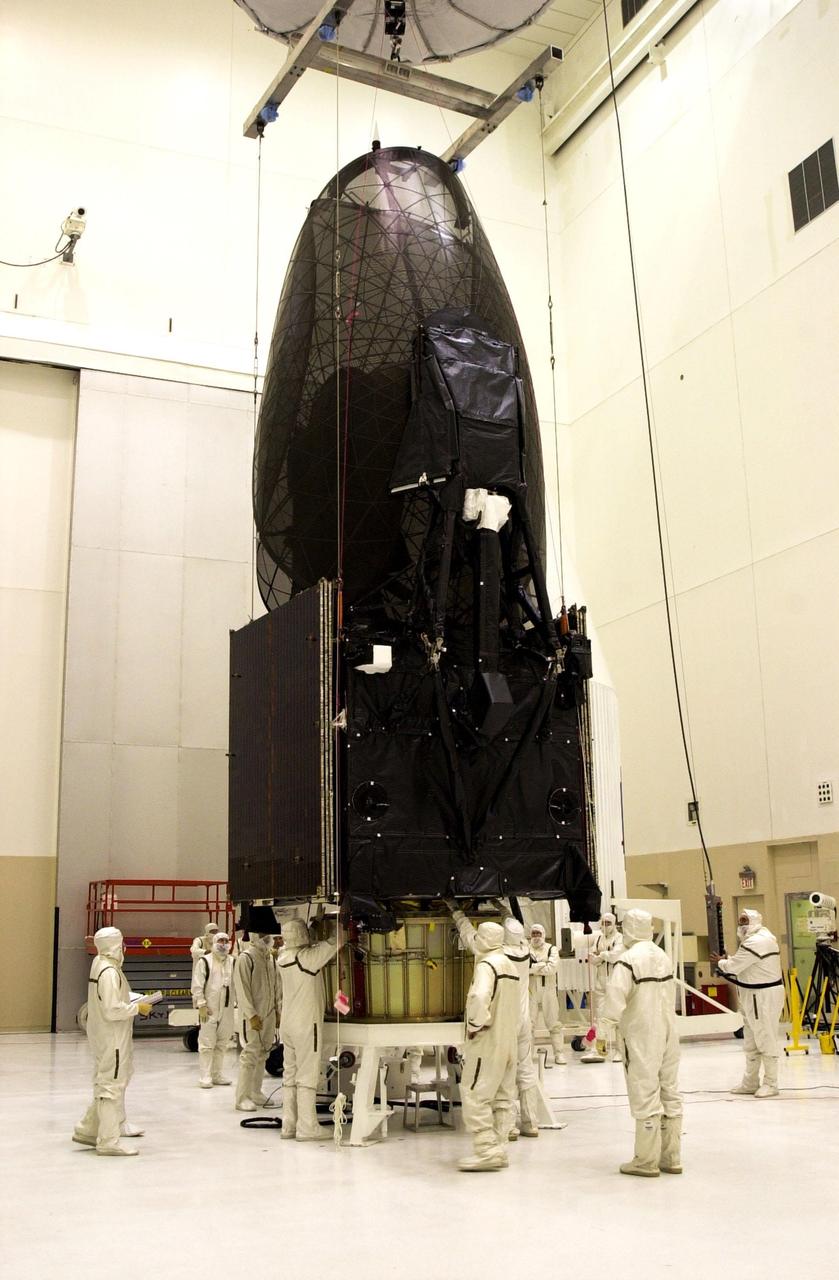 KENNEDY SPACE CENTER, Fla. - The Tracking and Data Relay Satellite-I (TDRS-I) is lifted for mating with the adapter of its nose fairing in the Spacecraft Assembly and Encapsulation Facility-2 (SAEF-2). The second in a new series of telemetry satellites, TDRS-I replenishes the existing on-orbit fleet of six spacecraft. The TDRS System is the primary source of space-to-ground voice, data and telemetry for the Space Shuttle. It also provides communications with the International Space Station and scientific spacecraft in low-Earth orbit such as the Hubble Space Telescope. This new advanced series of satellites will extend the availability of TDRS communications services until about 2017. Launch of TDRS-I is scheduled for March 8 aboard a Lockheed Martin Atlas IIA rocket from Pad 36-A, Cape Canaveral Air Force Station