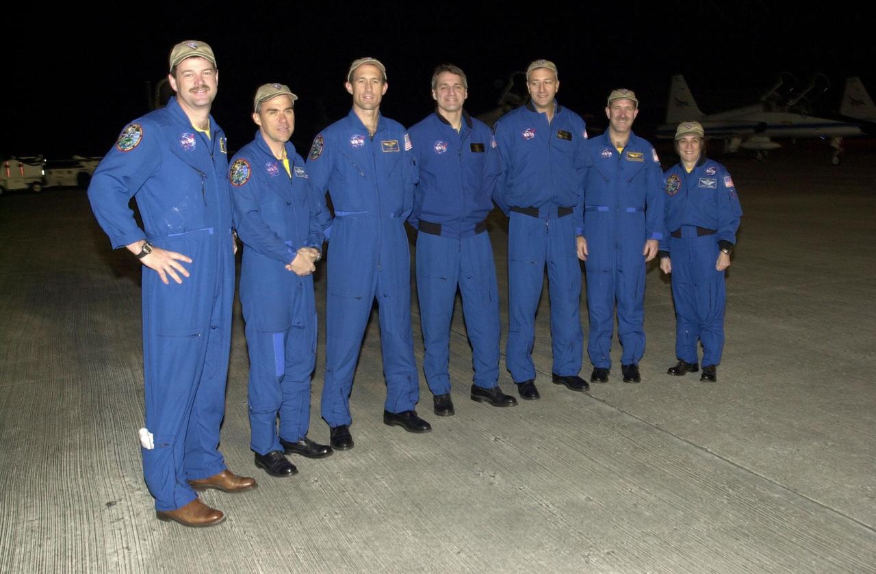 KENNEDY SPACE CENTER, Fla. - The STS-109 crew stops for a photograph after arriving at KSC aboard a T-38 jet aircraft to begin launch preparations.  Standing left to right are Commander Scott Altman, Pilot Duane Carey, and Mission Specialists James Newman, Richard Linnehan and Michael Massimino, Payload Commander John Grunsfeld, and Mission Specialist Nancy Currie.  The goal of the 11-day mission is repair and maintenance on the Hubble Space Telescope.  Five spacewalks are planned to replace Solar Array 2 with Solar Array 3, replace the Power Control Unit, remove the Faint Object Camera and install the Advanced Camera for Surveys (ACS), install the Near Infrared Camera and Multi-Object Spectrometer (NICMOS) Cooling System, and install New Outer Blanket Layer insulation.  Launch is scheduled for Feb. 28 at 6:48 a.m. EST