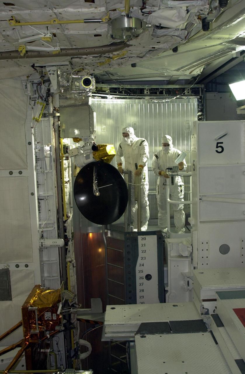 KENNEDY SPACE CENTER, Fla. -  On Launch Pad 39A, members of the STS-109 crew perform a final inspection of the Hubble payload they will deploy on orbit during five spacewalks.   The crew comprises Commander Scott Altman, Pilot Duane Carey, Payload Commander John Grunsfeld, and Mission Specialists Nancy Currie, James Newman, Richrd Linnehan and Michael Massimino.  The goal of the mission is to replace Solar Array 2 with Solar Array 3, replace the Power Control Unit, remove the Faint Object Camera and install the Advanced Camera for Surveys (ACS), install the Near Infrared Camera and Multi-Object Spectrometer (NICMOS) Cooling System, and install New Outer Blanket Layer insulation.  Launch of Shuttle Columbia on mission STS-109 is scheduled for Feb. 28 at 6:48 a.m. EST