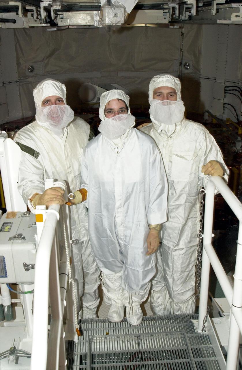 KENNEDY SPACE CENTER, Fla. - On Launch Pad 39A, members of the STS-109 crew pause during their final inspection of the Hubble payload they will deploy on orbit during five spacewalks.   Seen here (left to right) are Mission Specialists Michael Massimino, Nancy Currie and James Newman. The crew also comprises Commander Scott Altman, Pilot Duane Carey, Payload Commander John Grunsfeld, and Mission Specialist Richard Linnehan.  The goal of the mission is to replace Solar Array 2 with Solar Array 3, replace the Power Control Unit, remove the Faint Object Camera and install the Advanced Camera for Surveys (ACS), install the Near Infrared Camera and Multi-Object Spectrometer (NICMOS) Cooling System, and install New Outer Blanket Layer insulation.  Launch of Shuttle Columbia on mission STS-109 is scheduled for Feb. 28 at 6:48 a.m. EST