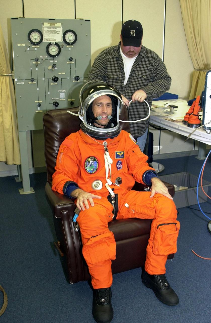 KENNEDY SPACE CENTER, FLA. --  STS-109 Mission Specialist James H. Newman gets a final fitting on his launch and entry suit two days before launch.  On mission STS-109, the seven-member crew will capture the Hubble Space Telescope using the Shuttle's robotic arm and secure it on a workstand in Columbia's payload bay.  Four mission specialists will perform five scheduled spacewalks to complete system upgrades to the telescope. More durable solar arrays, a large gyroscopic assembly to help point the telescope properly, a new telescope power control unit, and a cooling system to restore the use of a key infrared camera and spectrometer unit, which has been dormant since 1999, will all be installed.  In addition, the telescope’s view of the Universe will be improved with the addition of the Advanced Camera for Surveys (ACS), which replaces the Faint Object Camera, the last of Hubble's original instruments.  The STS-109 crew also includes Commander Scott D. Altman, Pilot Duane G. Carey, and Mission Specialists John M. Grunsfeld, Nancy J. Currie, Richard M. Linnehan and Michael J. Massimino.  Launch is scheduled for Feb. 28, 2002, at 6:48 a.m. EST (11:48 GMT)