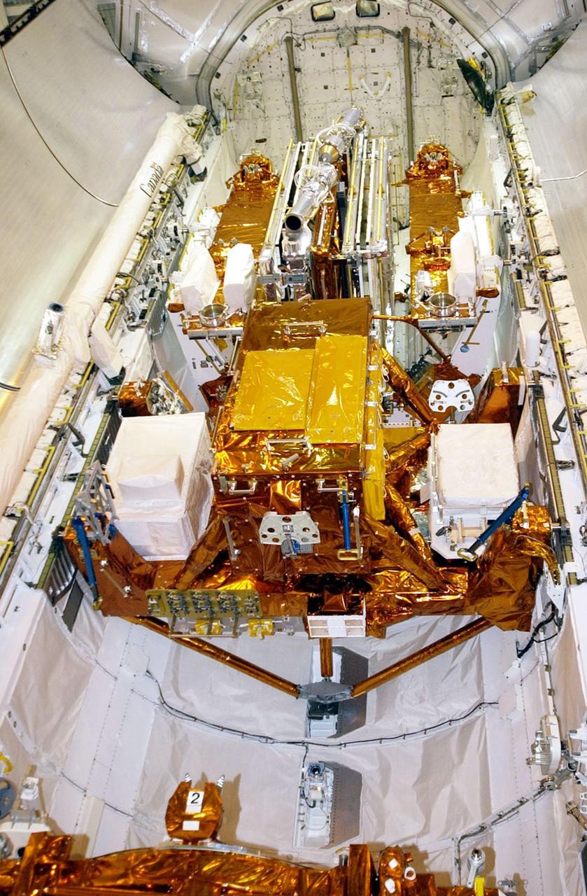 KENNEDY SPACE CENTER, FLA. --   The STS-109 payload sits in place inside Columbia’s payload bay.  On mission STS-109, the seven-member crew will capture the Hubble Space Telescope using the Shuttle's robotic arm and secure it on a workstand in Columbia’s payload bay.  Four mission specialists will perform five scheduled spacewalks to complete system upgrades to the telescope. More durable solar arrays, a large gyroscopic assembly to help point the telescope properly, a new telescope power control unit, and a cooling system to restore the use of a key infrared camera and spectrometer unit, which has been dormant since 1999, will all be installed. In addition, the telescope's view of the Universe will be improved with the addition of the Advanced Camera for Surveys (ACS), which replaces the Faint Object Camera, the last of Hubble's original instruments.  The STS-109 crew includes Commander Scott D. Altman, Pilot Duane G. Carey, and Mission Specialists John M. Grunsfeld, Nancy J. Currie, James H. Newman, Richard M. Linnehan and Michael J. Massimino.  Launch is scheduled for Feb. 28, 2002, at 6:48 a.m. EST (11:48 GMT). 