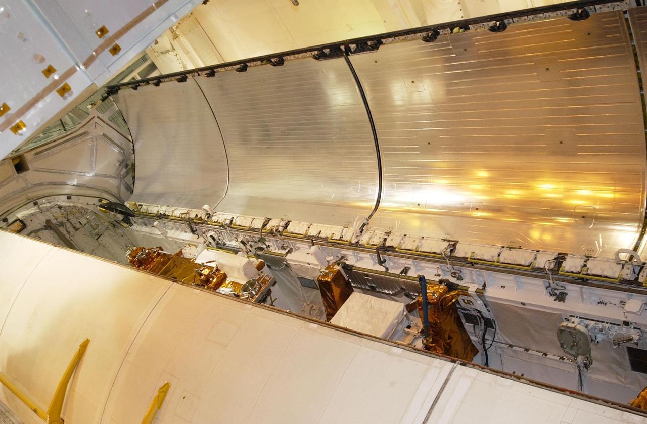 KENNEDY SPACE CENTER, Fla. -  Columbia’s payload bay doors begin closing over the equipment inside to be used on mission STS-109.  During their 11 days in space,   the seven-member crew will capture the Hubble Space Telescope using the Shuttle's robotic arm and secure it on a workstand in Columbia’s payload bay.  Four mission specialists will perform five scheduled spacewalks to complete system upgrades to the telescope. More durable solar arrays, a large gyroscopic assembly to help point the telescope properly, a new telescope power control unit, and a cooling system to restore the use of a key infrared camera and spectrometer unit, which has been dormant since 1999, will all be installed. In addition, the telescope's view of the Universe will be improved with the addition of the Advanced Camera for Surveys (ACS), which replaces the Faint Object Camera, the last of Hubble's original instruments.  The STS-109 crew includes Commander Scott D. Altman, Pilot Duane G. Carey, and Mission Specialists John M. Grunsfeld, Nancy J. Currie, James H. Newman, Richard M. Linnehan and Michael J. Massimino.  Launch is scheduled for Feb. 28, 2002, at 6:48 a.m. EST (11:48 GMT). 