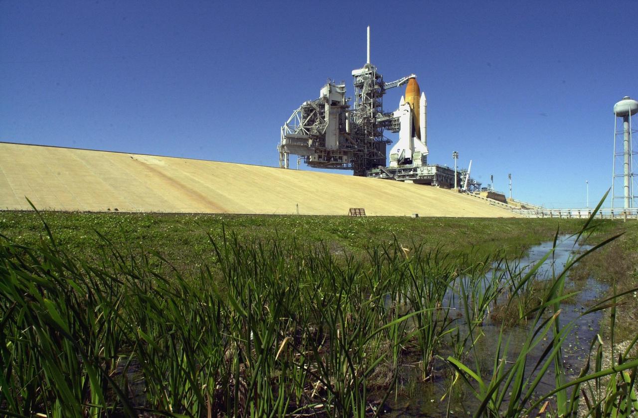 KENNEDY SPACE CENTER, FLA. -- The Rotating Service Structure is rolled back from Space Shuttle Columbia in preparation for launch Feb. 28, 2002, at 6:48 a.m. EST (11:48 GMT) on mission STS-109. In the photo is seen the Orbiter Access Arm stretched to Columbia's cockpit. A Hubble Servicing Mission, the goal of STS-109 is to replace Solar Array 2 with Solar Array 3, replace the Power Control Unit, remove the Faint Object Camera and install the ACS, install the Near Infrared Camera and Multi-Object Spectrometer (NICMOS) Cooling System, and install New Outer Blanket Layer insulation.