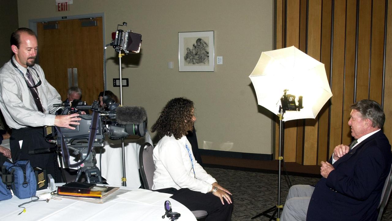 KENNEDY SPACE CENTER, FLA. --  KSC videographer Glen Benson (left) tapes an interview that Lucha Ray (center) is conducting with space pioneer Wally Schirra (right).  The occasion was the celebration of the 40th anniversary of American spaceflight.  The event was held at the KSC Visitor Complex Feb. 24, 2002