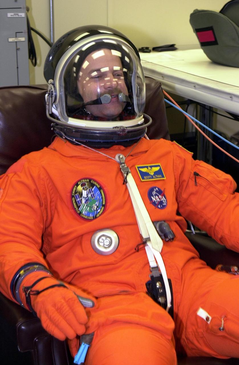 KENNEDY SPACE CENTER, Fla. - During suitup, STS-109 Commander Scott D. Altman gives a thumbs up for launch. Liftoff of Space Shuttle Columbia is scheduled for 6:22 a.m. EST March 1. On mission STS-109, the crew will capture the Hubble Space Telescope using the Shuttle's robotic arm and secure it on a workstand in Columbia's payload bay. Four mission specialists will perform five scheduled spacewalks to complete system upgrades to the telescope. More durable solar arrays, a large gyroscopic assembly to help point the telescope properly, a new telescope power control unit, and a cooling system to restore the use of a key infrared camera and spectrometer unit, which has been dormant since 1999, will all be installed. In addition, the telescope's view of the Universe will be improved with the addition of the Advanced Camera for Surveys (ACS), which replaces the Faint Object Camera, the last of Hubble's original instruments. Mission STS-109 is the 27th flight of the orbiter Columbia and the 108th flight overall in NASA's Space Shuttle program. After the 11-day mission, Columbia is scheduled to land about 4:35 a.m. EST March 12