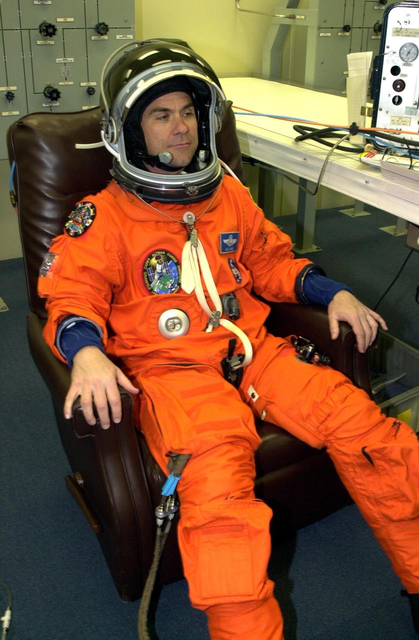 KENNEDY SPACE CENTER, FLA. - STS-109 Pilot Duane G. Carey suits up for launch, scheduled for 6:22 a.m. EST March 1. On mission STS-109, the crew will capture the Hubble Space Telescope using the Shuttle's robotic arm and secure it on a workstand in Columbia's payload bay. Four mission specialists will perform five scheduled spacewalks to complete system upgrades to the telescope. More durable solar arrays, a large gyroscopic assembly to help point the telescope properly, a new telescope power control unit, and a cooling system to restore the use of a key infrared camera and spectrometer unit, which has been dormant since 1999, will all be installed. In addition, the telescope's view of the Universe will be improved with the addition of the Advanced Camera for Surveys (ACS), which replaces the Faint Object Camera, the last of Hubble's original instruments. Mission STS-109 is the 27th flight of the orbiter Columbia and the 108th flight overall in NASA's Space Shuttle program. After the 11-day mission, Columbia is scheduled to land about 4:35 a.m. EST March 12