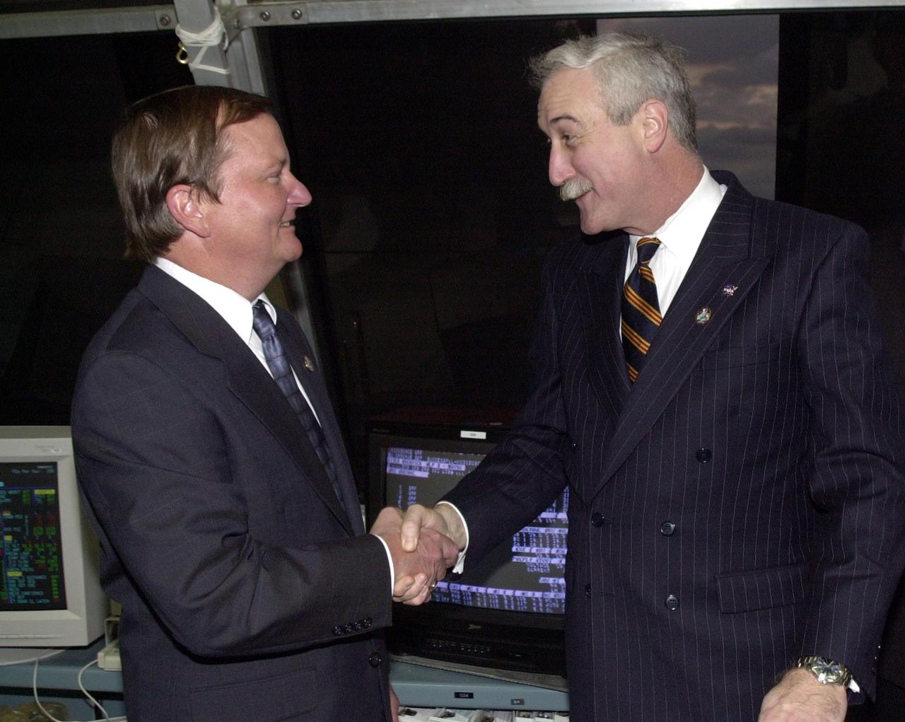 KENNEDY SPACE CENTER, Fla. -  In the firing room, NASA Administrator Sean O'Keefe (right) congratulates Launch Director Mike Leinbach for the successful on-time launch of Space Shuttle Columbia.  Liftoff occurred at 6:22:02:08 a.m. EST (11:22:02:08 GMT).  Columbia is on its 27th flight and the 108th flight of the Shuttle Program.  The goal of the mission is the maintenance and upgrade of the Hubble Space Telescope, to be carried out in five spacewalks.  The crew of STS-109 comprises Commander Scott D. Altman, Pilot Duane G. Carey, Payload Commander John M. Grunsfeld, and Mission Specialists Nancy Jane Currie, Richard M. Linnehan, James H. Newman and Michael J. Massimino.  After an 11-day mission, Columbia is expected to return to Kennedy March 12 about 4:35 a.m. EST (09:35 GMT)