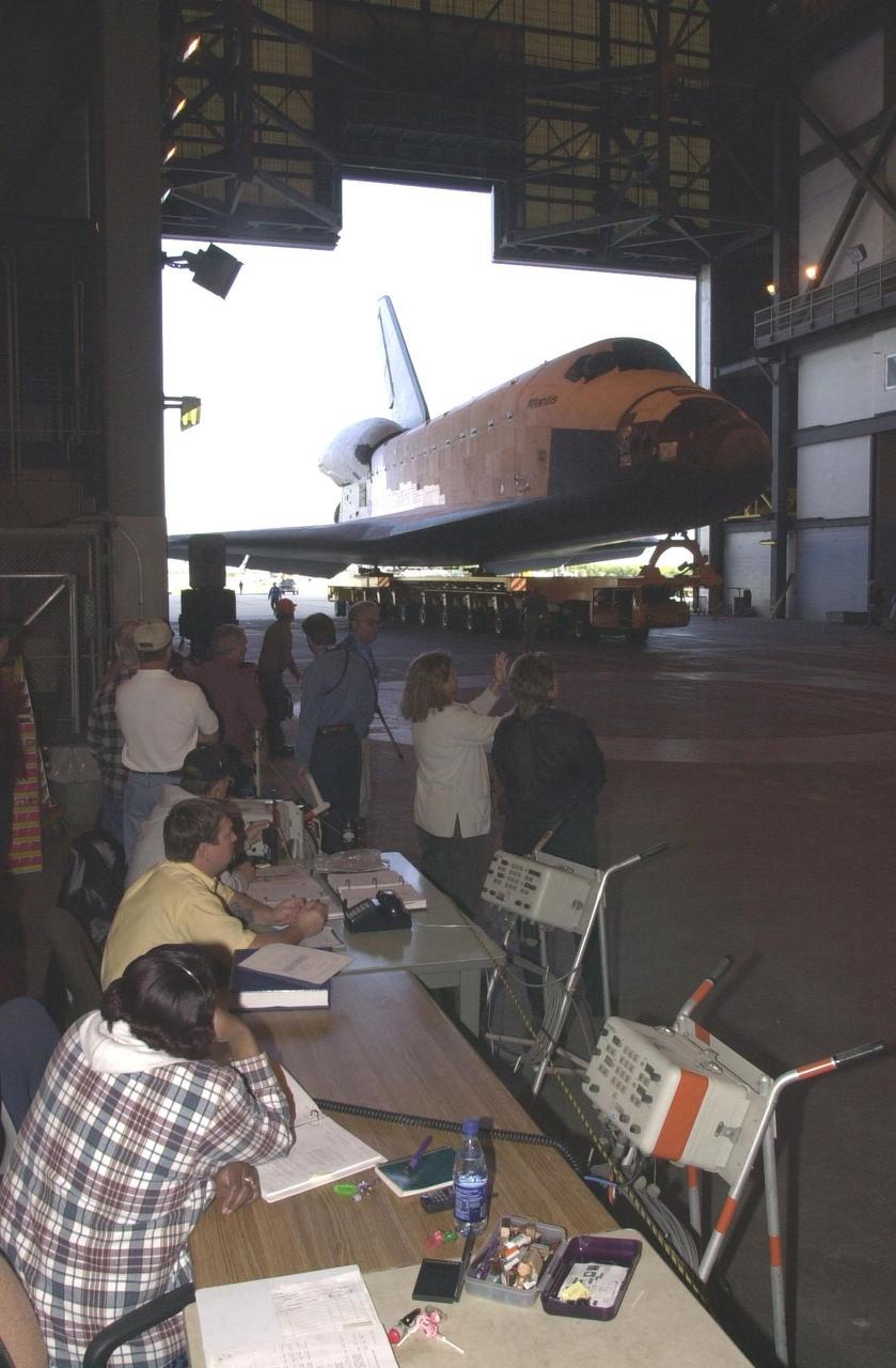 KENNEDY SPACE CENTER, Fla. - With employees watching, Orbiter Atlantis rolls into the Vehicle Assembly Building for space vehicle mate.  As part of final preparations before transfer to the launch pad, Atlantis will be lifted vertically into its VAB high bay and mated to the twin solid rocket boosters and external tank.  The STS-110 mission resumes International Space Station assembly operations with the delivery of the S0 truss, which will support solar panels providing additional power to the Station.  The payload will also include the first part of a Mobile Transporter that will provide a moveable base for the Station’s Canadian robotic arm.  STS-110 is scheduled for launch April 4