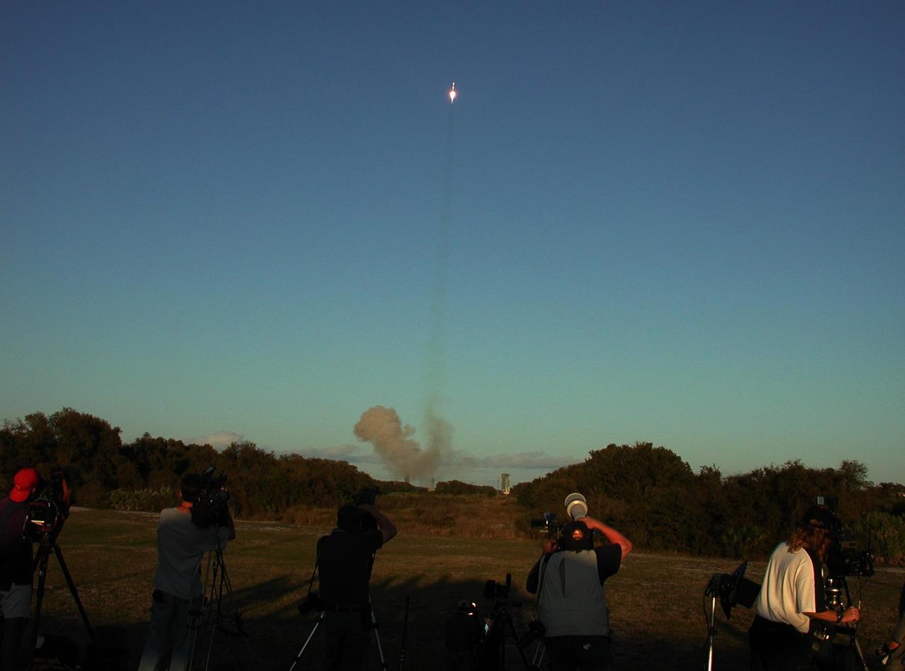 KENNEDY SPACE CENTER, FLA. --  Photographers track the Lockheed Martin Atlas IIA rocket after liftoff from Launch Pad 36-A, Cape Canaveral Air Force Station. The rocket is carrying the Tracking and Data Relay Satellite-I (TDRS-1).  TDRS-I replenishes the existing on-orbit fleet of six spacecraft. The TDRS System is the primary source of space-to-ground voice, data and telemetry for the Space Shuttle. It also provides communications with the International Space Station and scientific spacecraft in low-Earth orbit such as the Hubble Space Telescope. This new advanced series of satellites will extend the availability of TDRS communications services until about 2017. Liftoff occurred at 5:59 p.m. EST