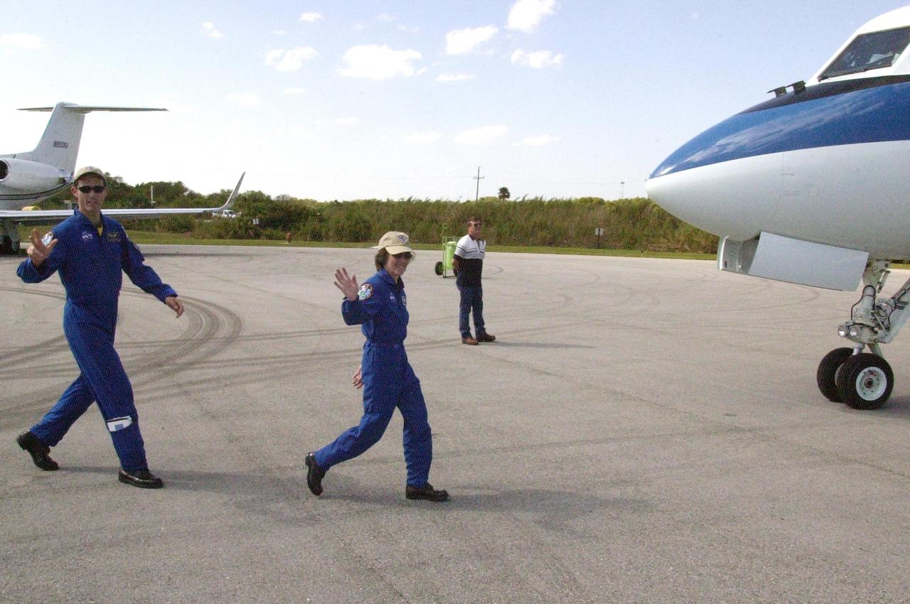 KENNEDY SPACE CENTER, FLA. - At the Cape Canaveral Air Force Station Skid Strip, STS-109 Mission Specialists James Newman and Nancy Currie wave to onlookers as they head for the aircraft and departure for Houston. The crew returned to KSC aboard Columbia March 12 after an 11-day mission servicing the Hubble Space Telescope.  The other crew members are Commander Scott Altman, Pilot Duane Carey and Mission Specialists John Grunsfeld, Richard Linnehan and Michael Massimino