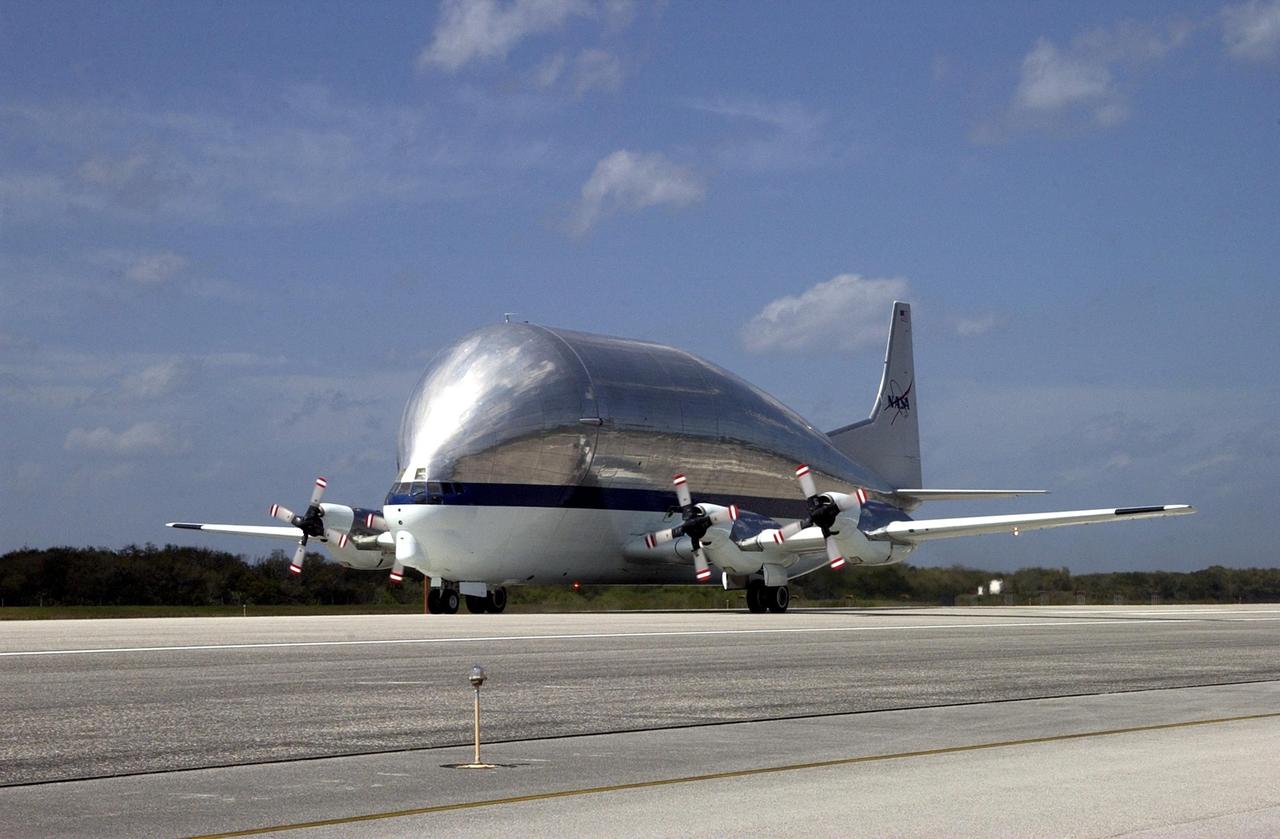 KENNEDY SPACE CENTER, FLA. -- The super Guppy transport aircraft arrives at KSC with its cargo, the S5 truss segment for the International Space Station. After offloading, the S5 truss will be transferred to the Space Station Processing Facility where it will be fit chedked for a Photo-Voltaic Radiator Grapple Fixture. It will also undergo a fit check to a truss simulator to make sure S5 will fit together with the S4 and S6 truss segments. S5 is scheduled for launch in October 2003 on mission STS-118. It will be the 10th truss assembled as part of a total 11 trusses.