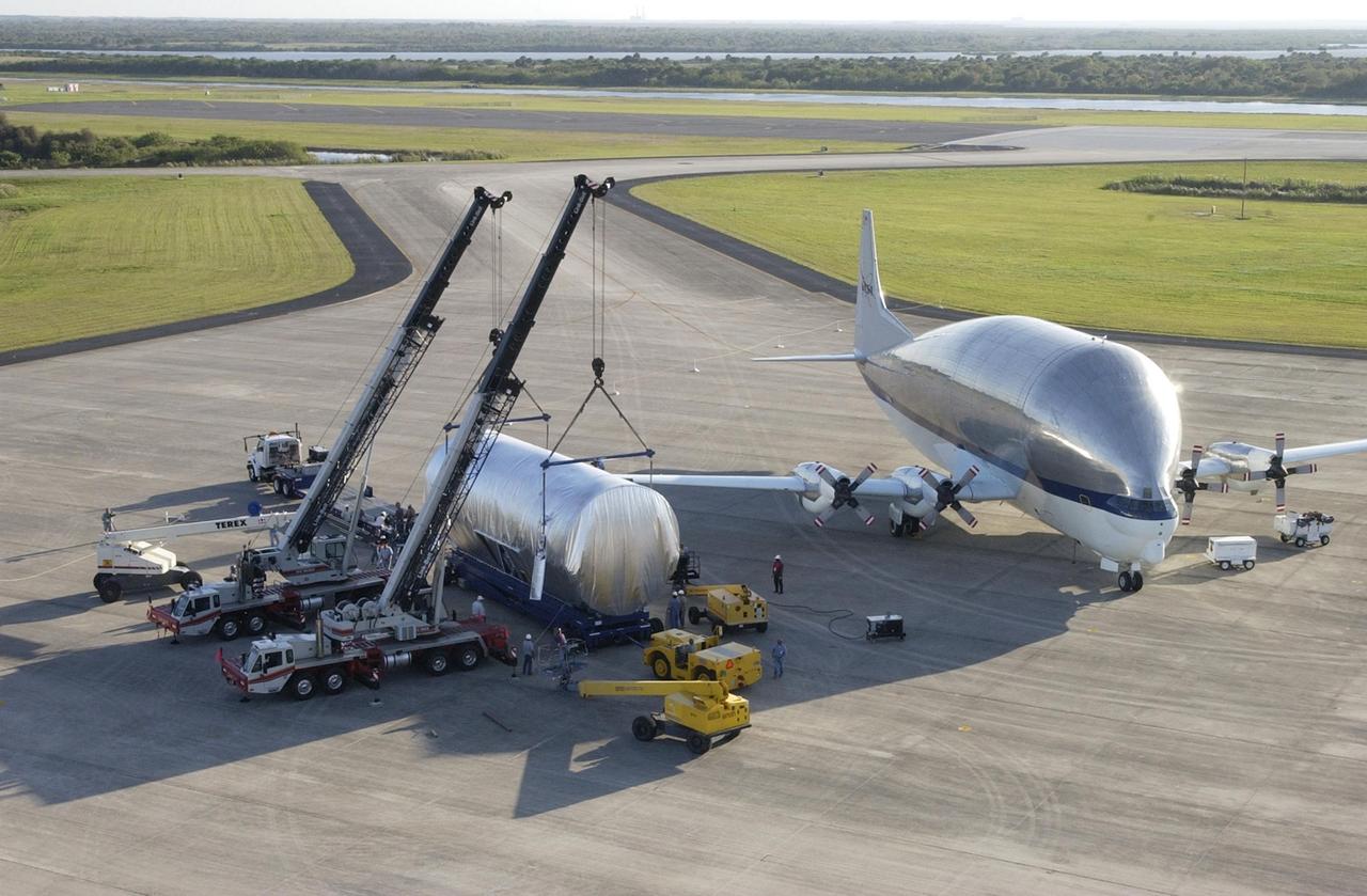 KENNEDY SPACE CENTER, FLA. -- At the Shuttle Landing Facility, the S5 truss segment for the International Space Station is prepared for ground transport after being offloaded from the Super Guppy transport aircraft on which it arrived. The S5 truss will be taken to the Space Station Processing Facility where it will be fit checked for a Photo-Voltaic Radiator Grapple Fixture. It will also undergo a fit check to a truss simulator to ensure that it will fit properly with the S4 and S6 truss segments. S5 is scheduled for launch in October 2003 on mission STS-118. It will be the tenth truss assembled in an 11-truss structure.