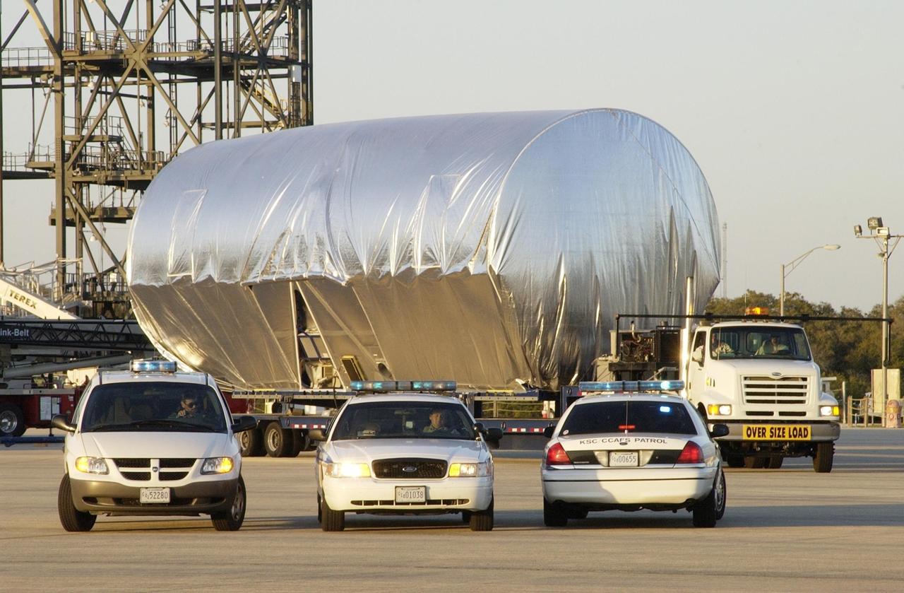 KENNEDY SPACE CENTER, FLA. -- At the Shuttle Landing Facility, the S5 truss segment for the International Space Station passes in front of the mate/demate device as it begins its move to the Space Station Processing Facility. There it will be fit checked for a Photo-Voltaic Radiator Grapple Fixture. It will also undergo a fit check to a truss simulator to ensure that it will fit properly with the S4 and S6 truss segments. S5 is scheduled for launch in October 2003 on mission STS-118. It will be the tenth truss assembled in an 11-truss structure