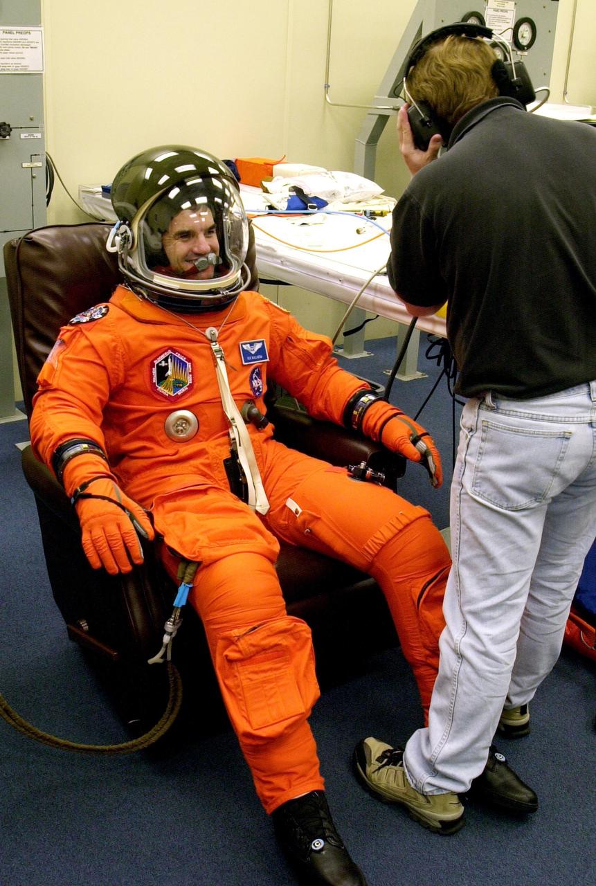 KENNEDY SPACE CENTER, FLA. -- During Terminal Countdown Demonstration Test activities, STS-110 Mission Specialist Rex Walheim has his launch and entry suit checked for fit. The TCDT is held at KSC prior to each Space Shuttle flight to provide flight crews an opportunity to participate in simulated launch countdown activities. Scheduled for launch April 4, the 11-day mission will feature Shuttle Atlantis docking with the International Space Station (ISS) and delivering the S0 truss, the centerpiece-segment of the primary truss structure that will eventually extend over 300 feet. 